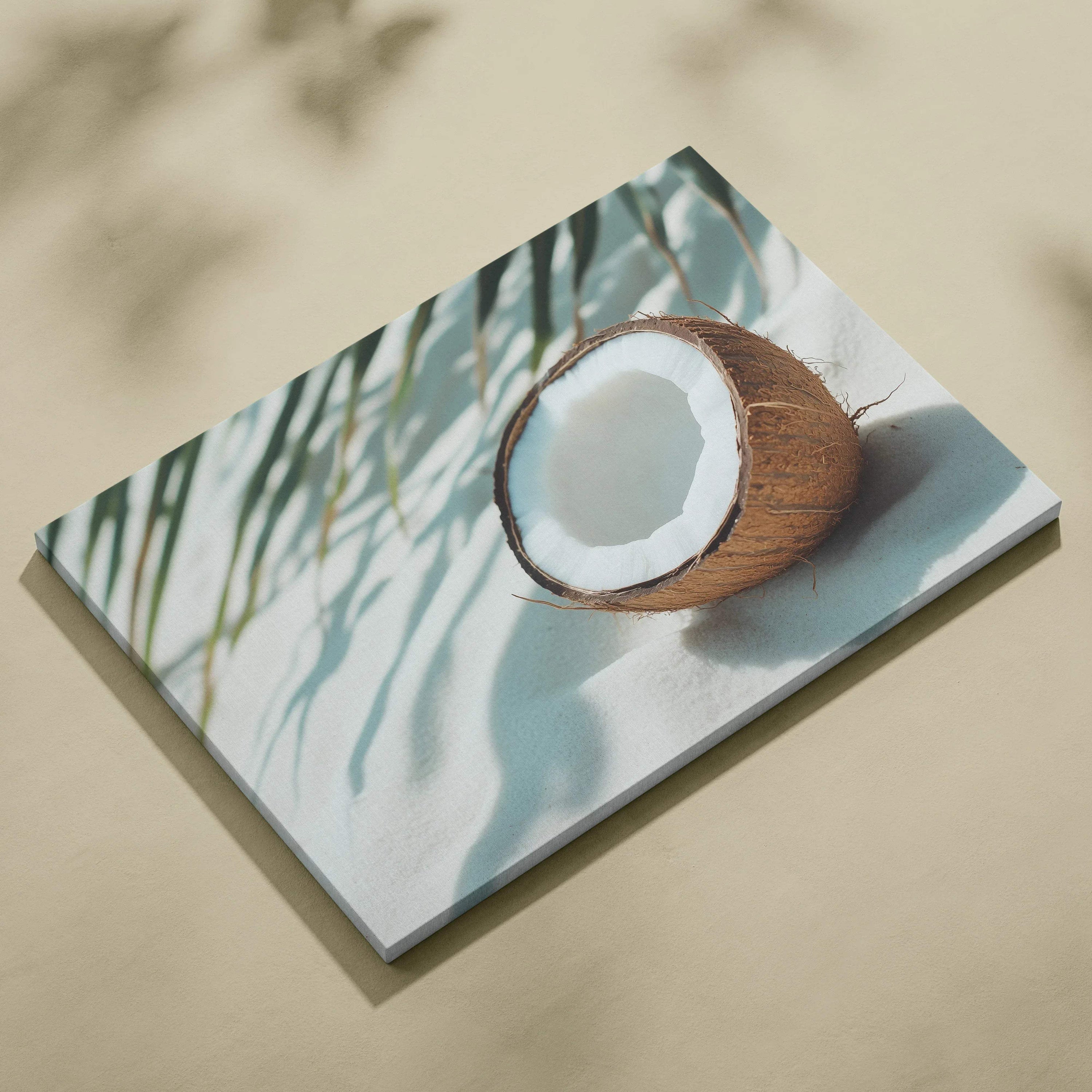Canvas wall art featuring a cracked coconut casting shadows on a white surface with palm leaves above.