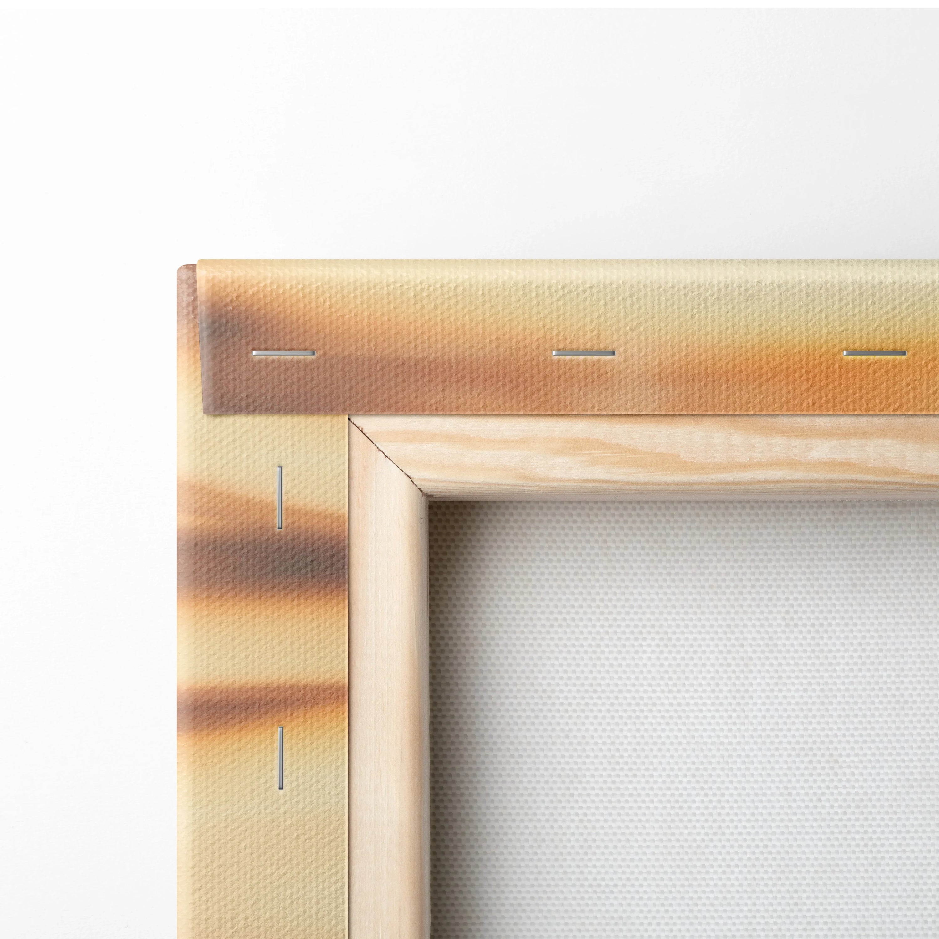 Close-up of canvas print corner with vivid orange and brown tropical sunset colors stretched over a wooden frame, showcasing