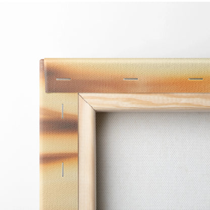 Close-up of canvas print corner with vivid orange and brown tropical sunset colors stretched over a wooden frame, showcasing