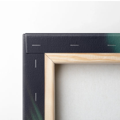 Corner view of a stretched canvas with wooden frame and black painted edge showing green and blue hues.