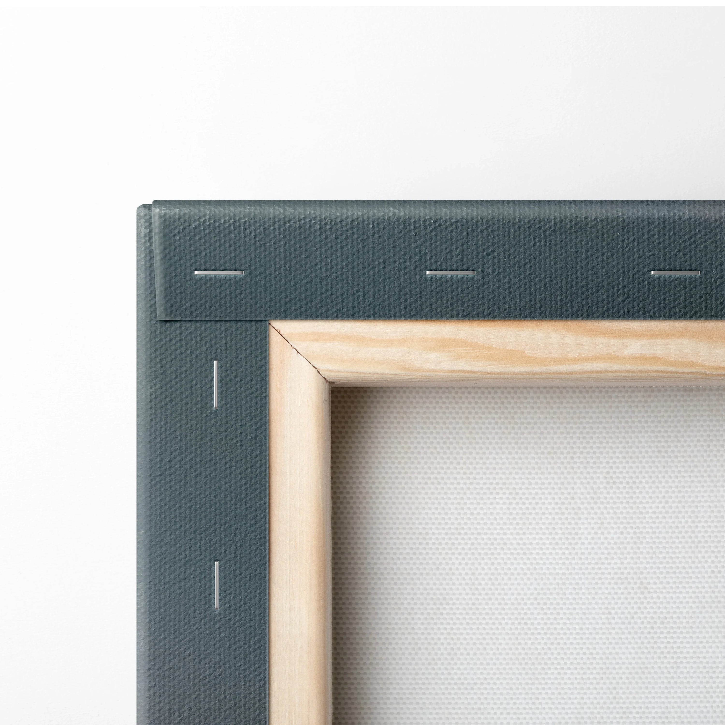 Close-up of wooden frame corner and stapled canvas back in neutral tones for wall art canvas.