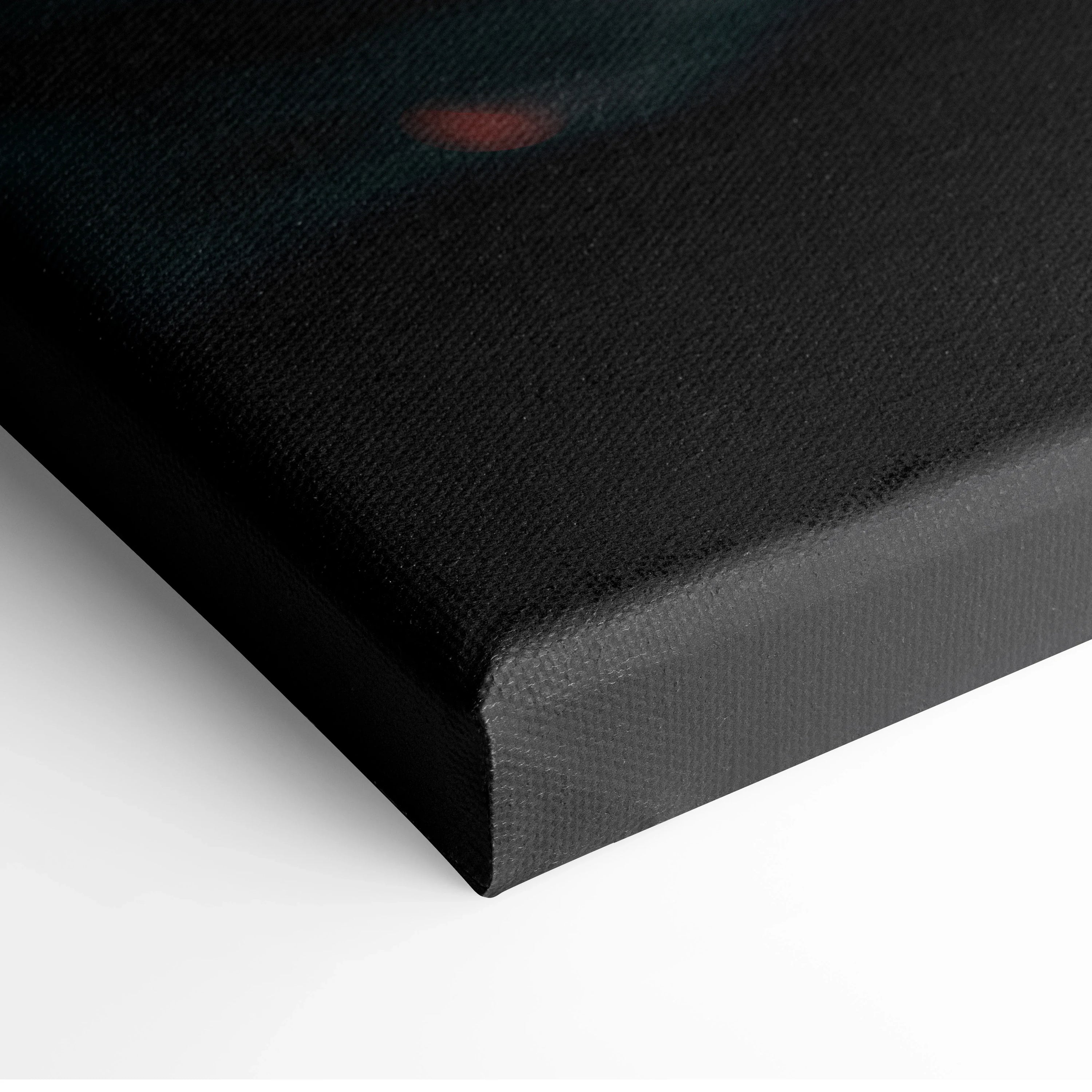 Close-up of black edge and corner of stretched canvas wall art with textured surface.