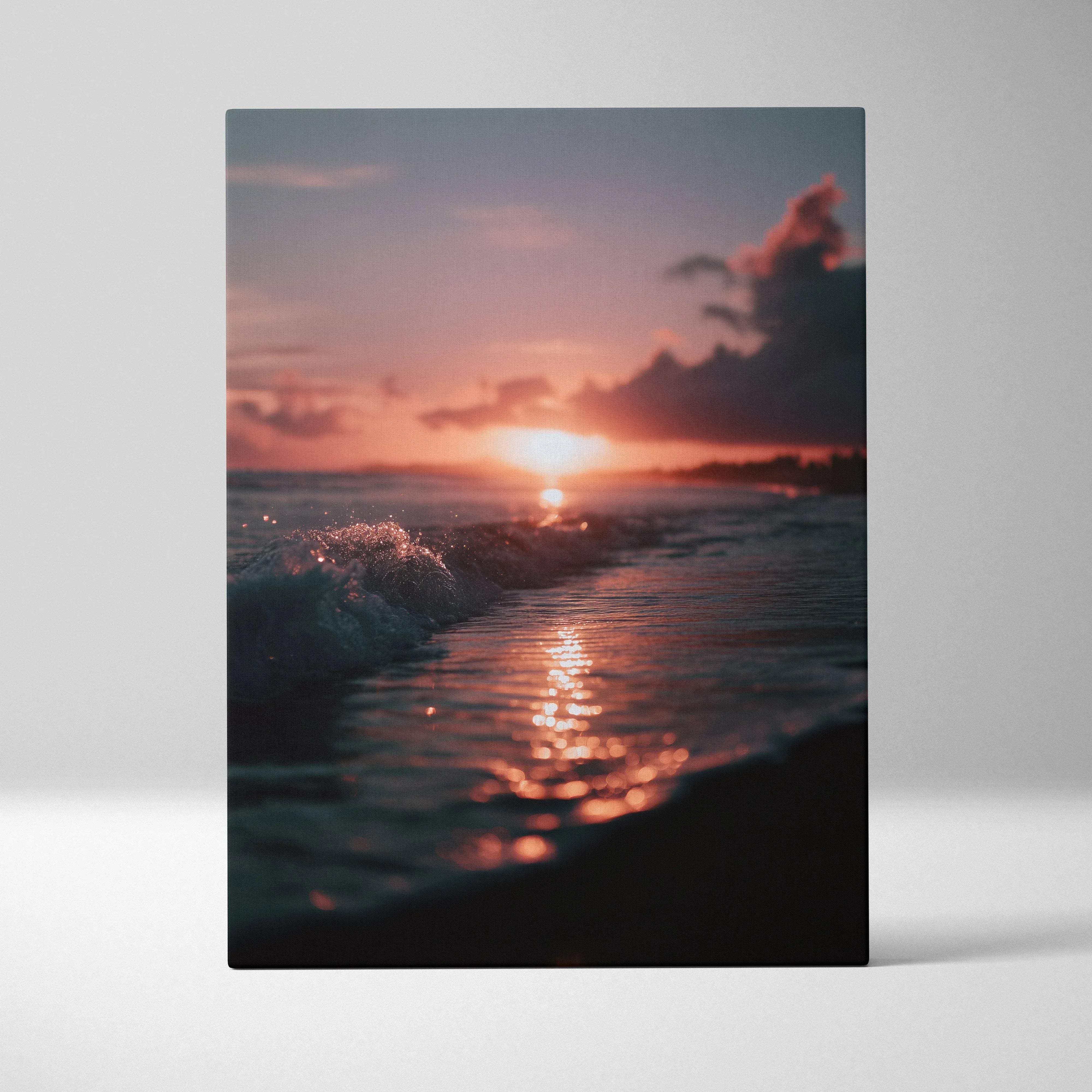 A rectangular canvas print of a tropical sunset coastal scene with warm orange and pink hues over ocean waves