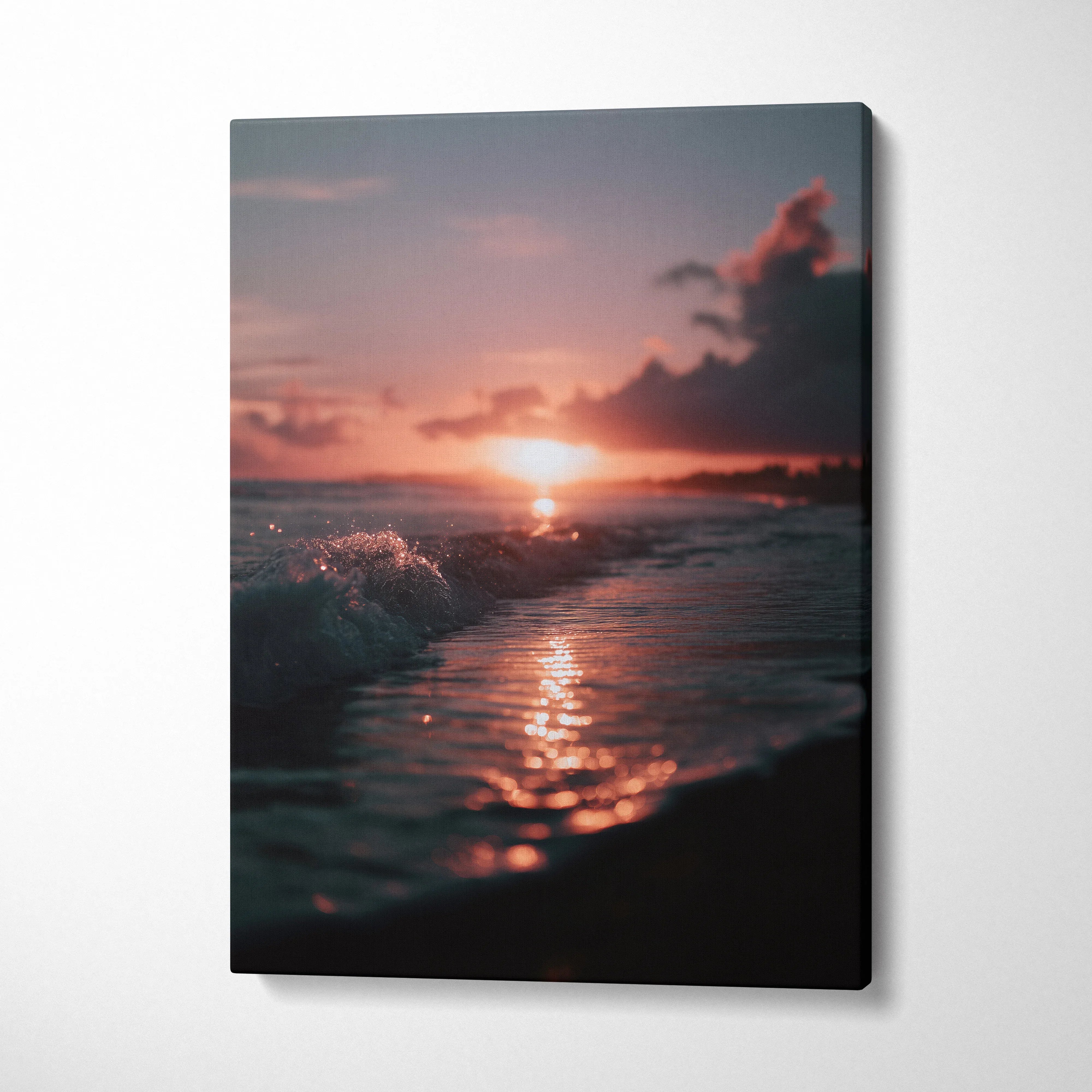 Vertical canvas wall art featuring tropical sunset over ocean waves with warm, glowing light and soft clouds.