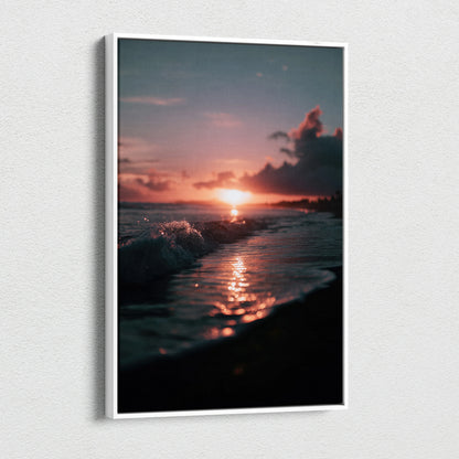 Canvas wall art of a tropical sunset with glowing orange sun over dark beach waves and silhouette palm trees.