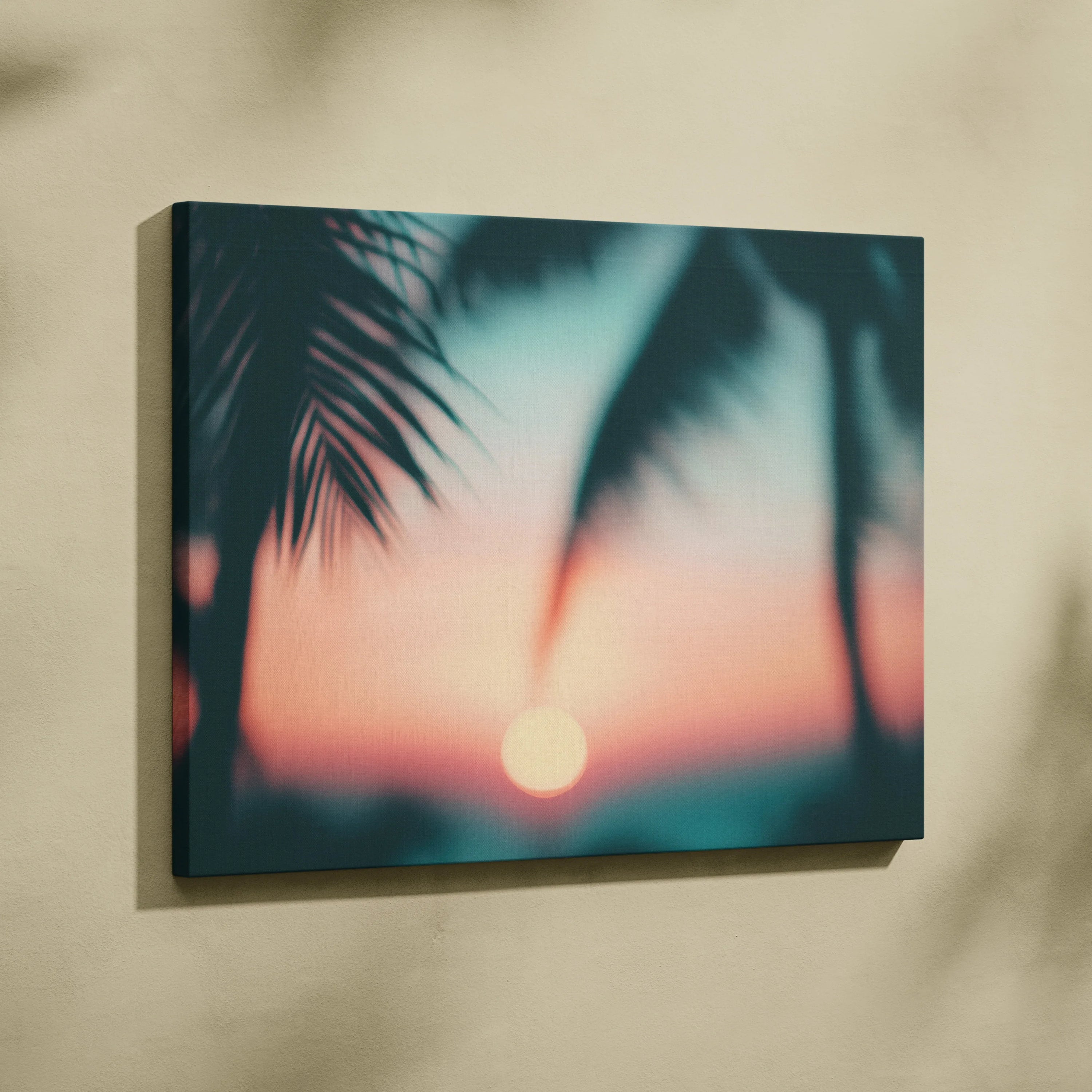 Canvas wall art featuring a tropical sunset with blurred palm silhouette leaves and soft beach scene decor.