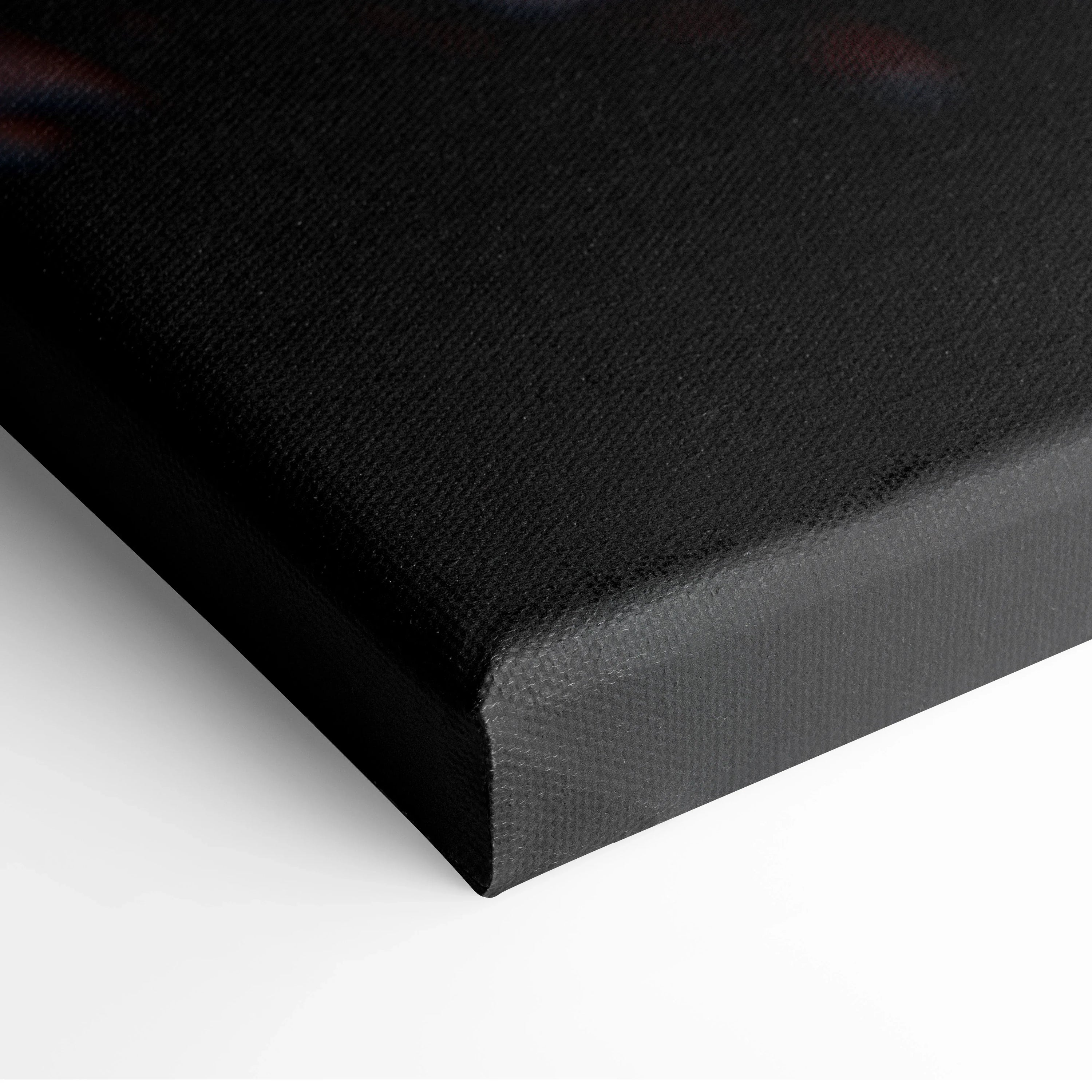 Close-up of black canvas wrap with textured fabric and sharp corner edges for wall art.