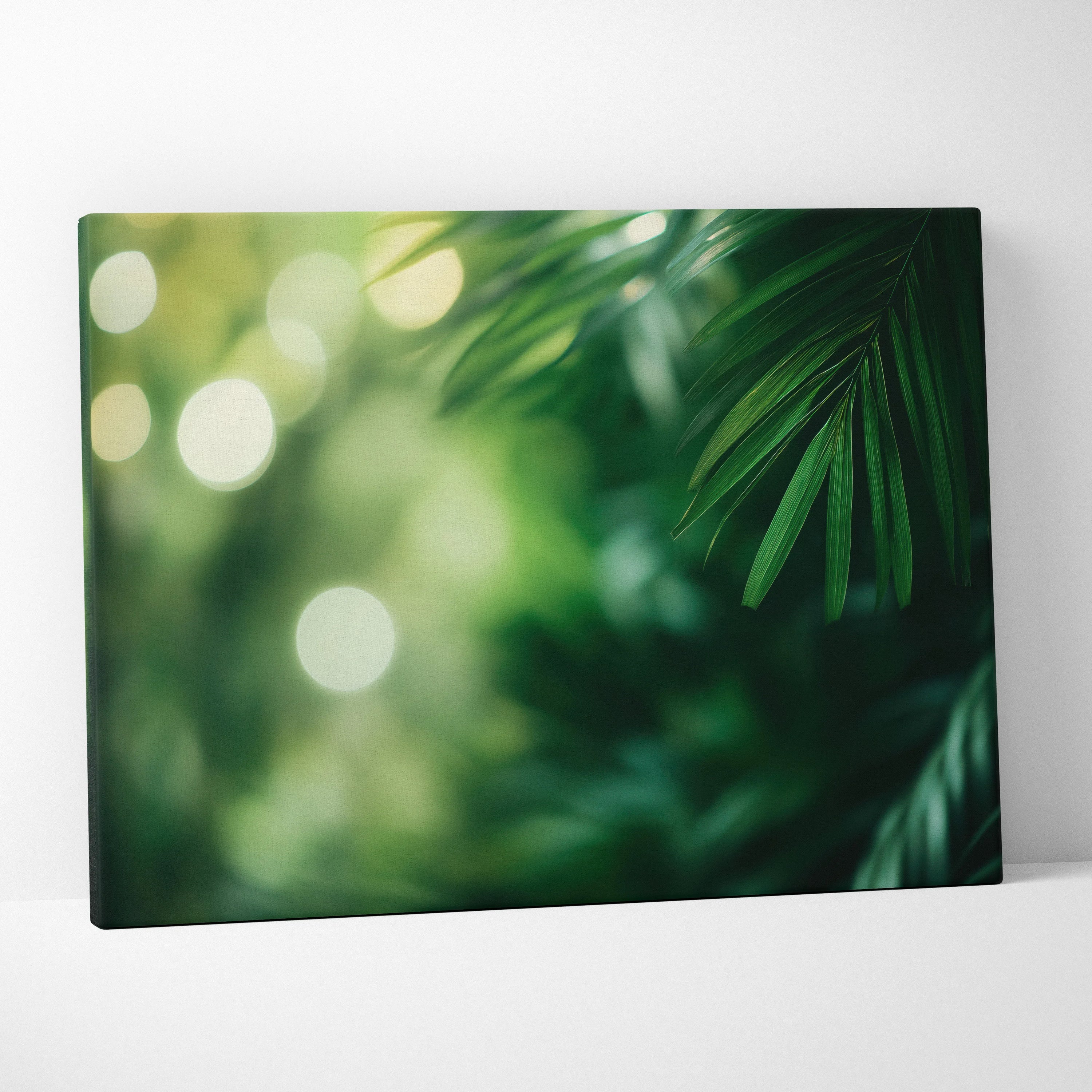 Canvas wall art featuring close-up digital art of green palm fronds with blurred tropical foliage background and soft light.