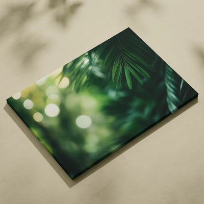Canvas wall art featuring green palm fronds and tropical leaves with soft bokeh light effects.