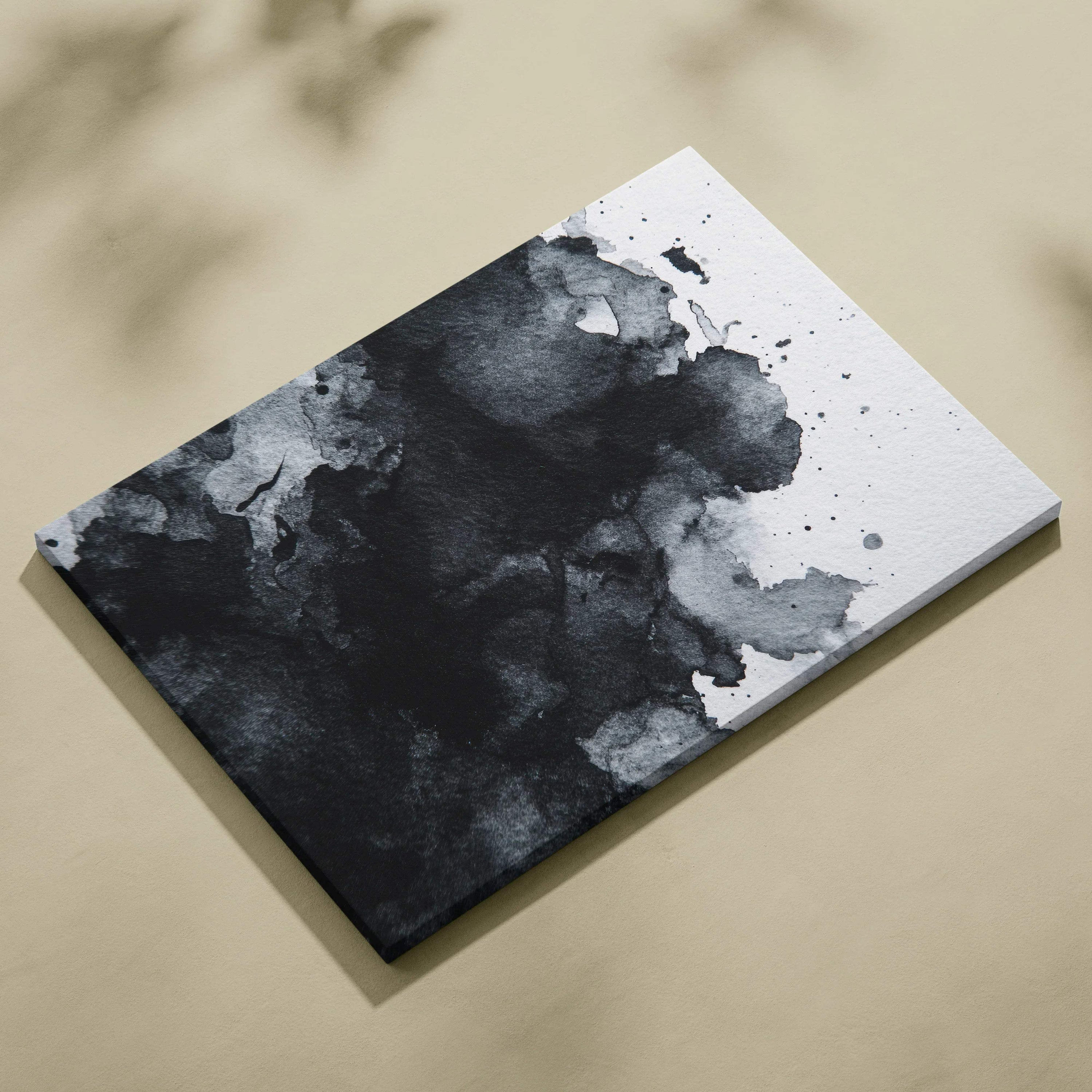 Abstract black and gray ink splash digital art on white canvas wall art with textured canvas surface.