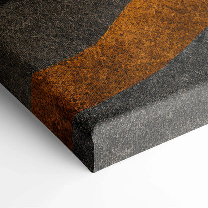 Canvas art with bold abstract shapes in dark gray, burnt orange, and charcoal tones on textured surface.