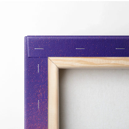 Purple canvas edge with red speckles and natural wooden frame detail of stretched wall art canvas.