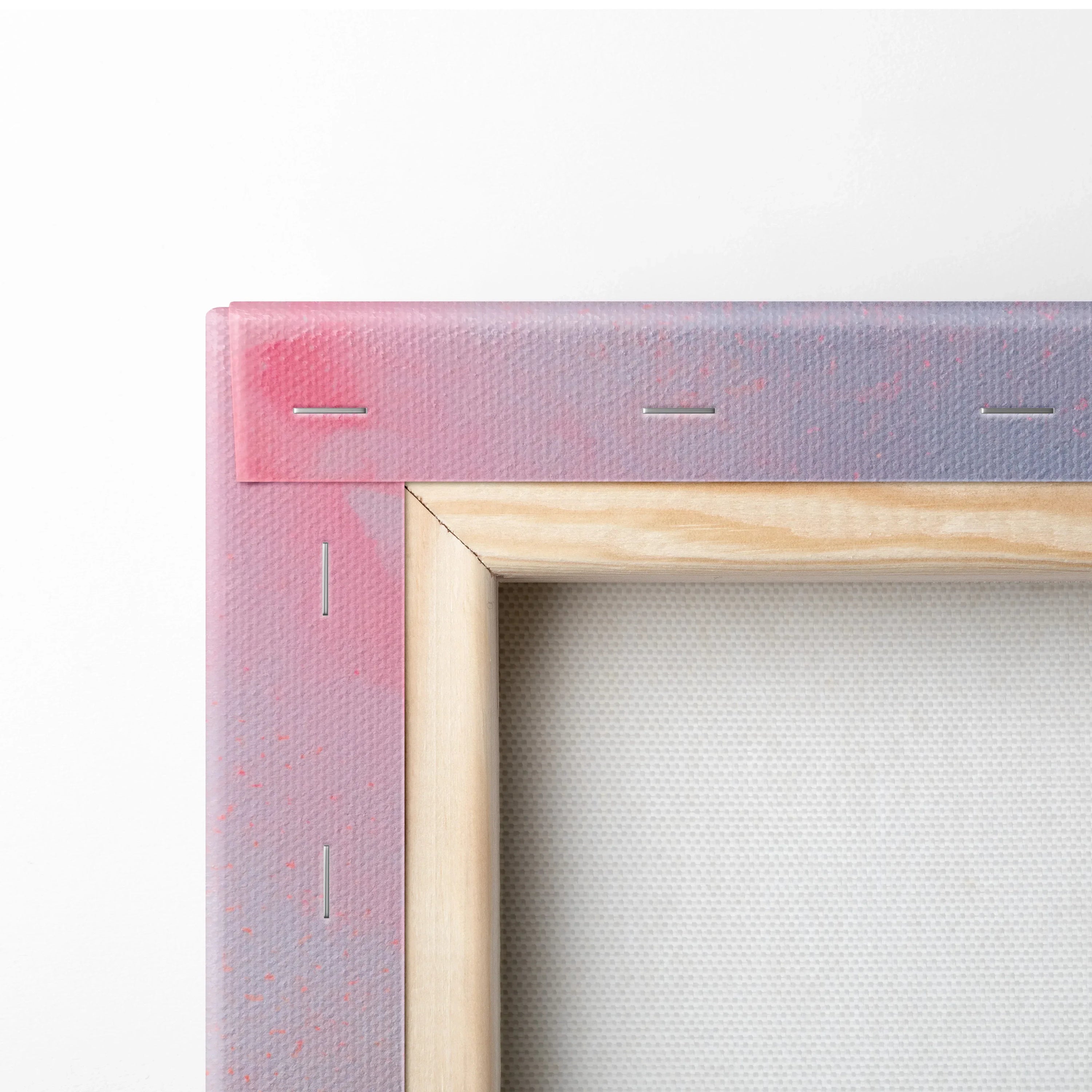 Close-up of stretched canvas corner with natural wood frame and abstract pink and purple digital art on canvas wall art.