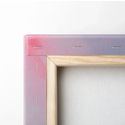 Close-up of stretched canvas corner with natural wood frame and abstract pink and purple digital art on canvas wall art.