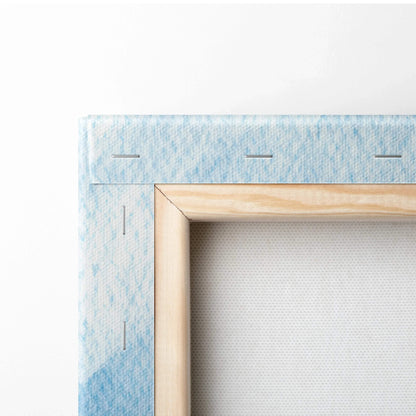 Close-up of a stretched canvas with light wood frame and blue abstract digital print on the edges.