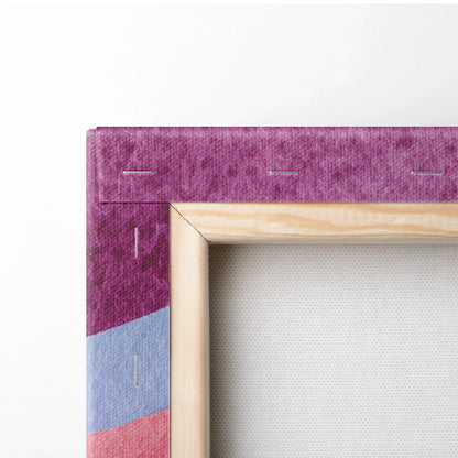 Close-up of canvas art with purple, blue, and pink abstract design stretched over wooden frame with visible staples.