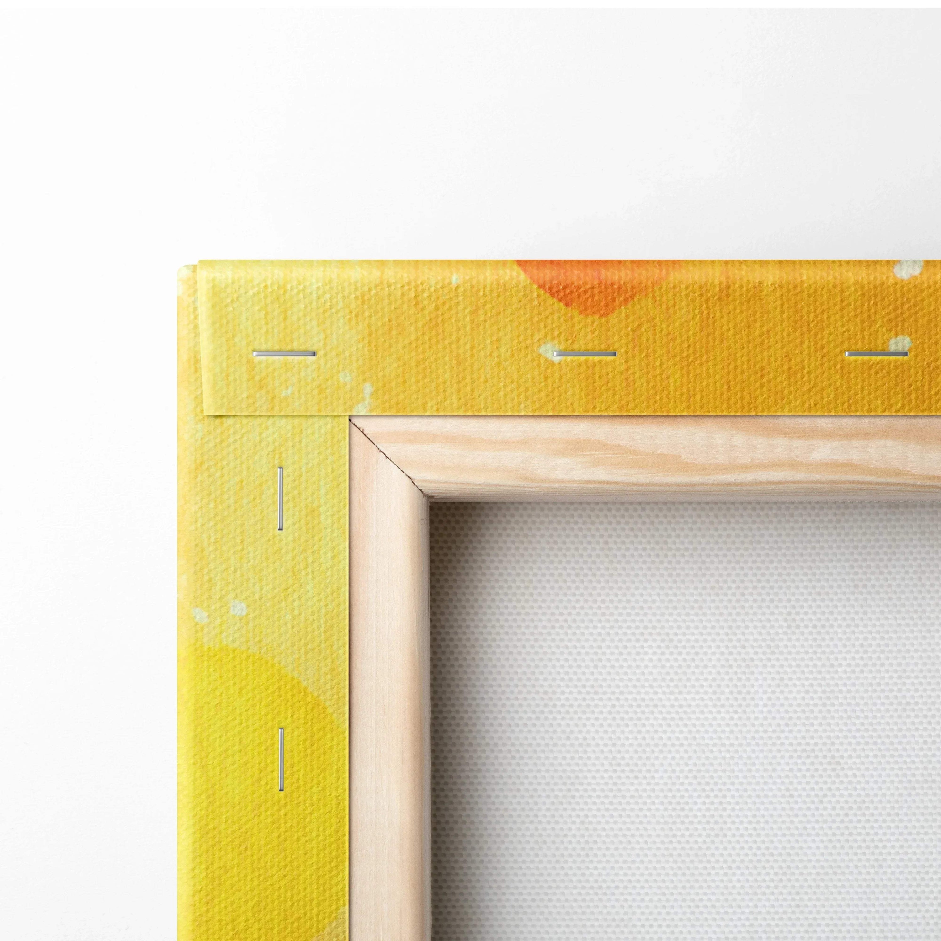 Close-up of abstract digital canvas art with bold yellow and orange patterns on wrapped edges and natural wood stretcher.