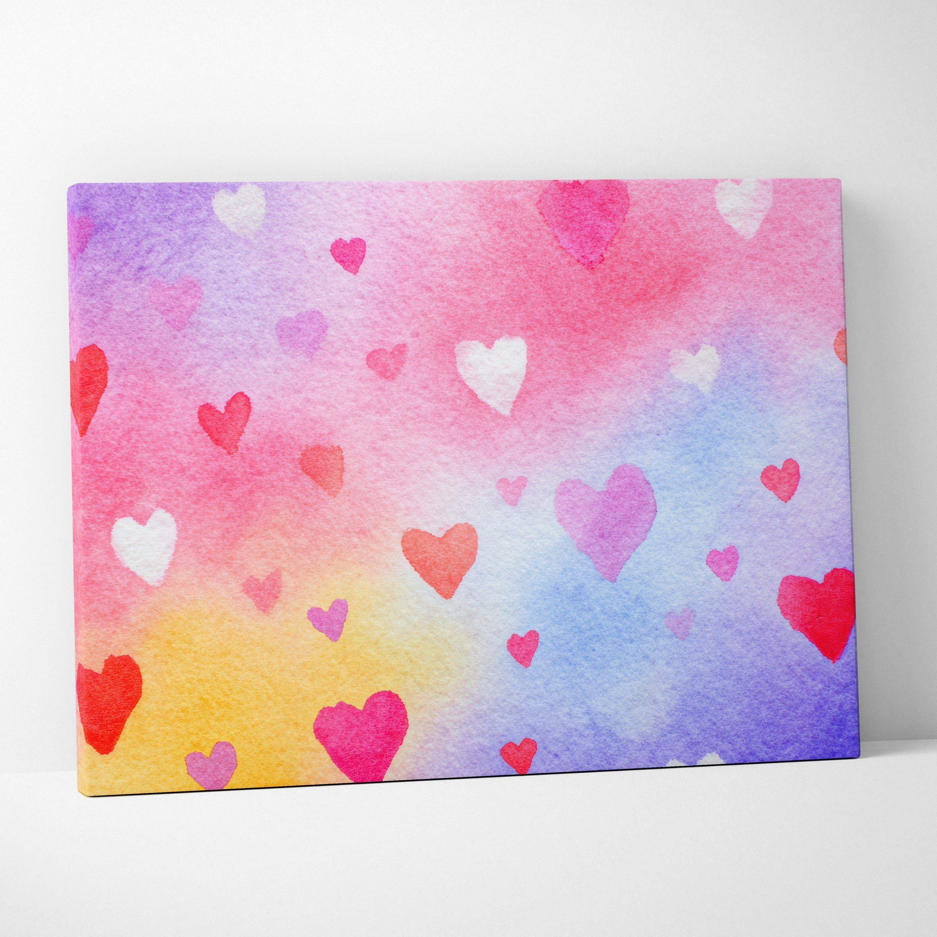 Colorful watercolor background with various pink and red heart shapes on canvas wall art.