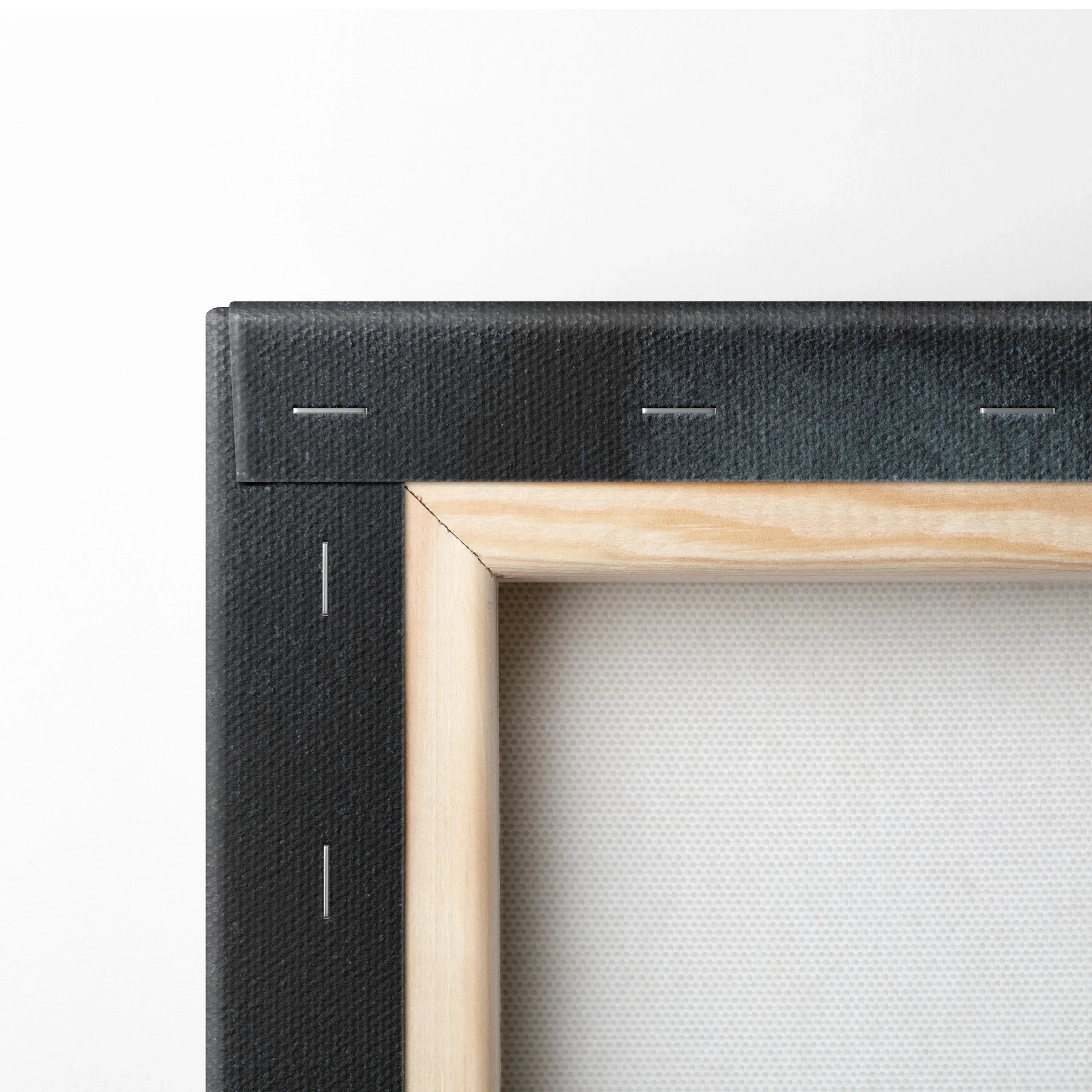 Close-up of stretcher frame with natural wood edge and tightly stretched white canvas art wall art.