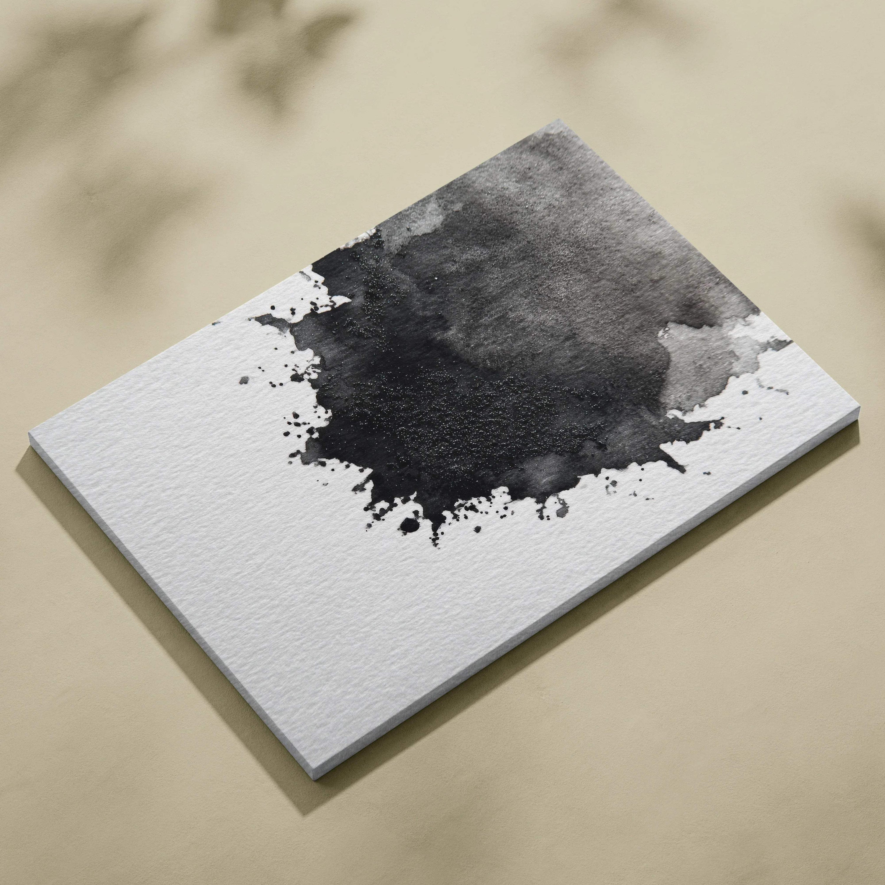 Rectangular white canvas art with black ink splash abstract design on textured surface.