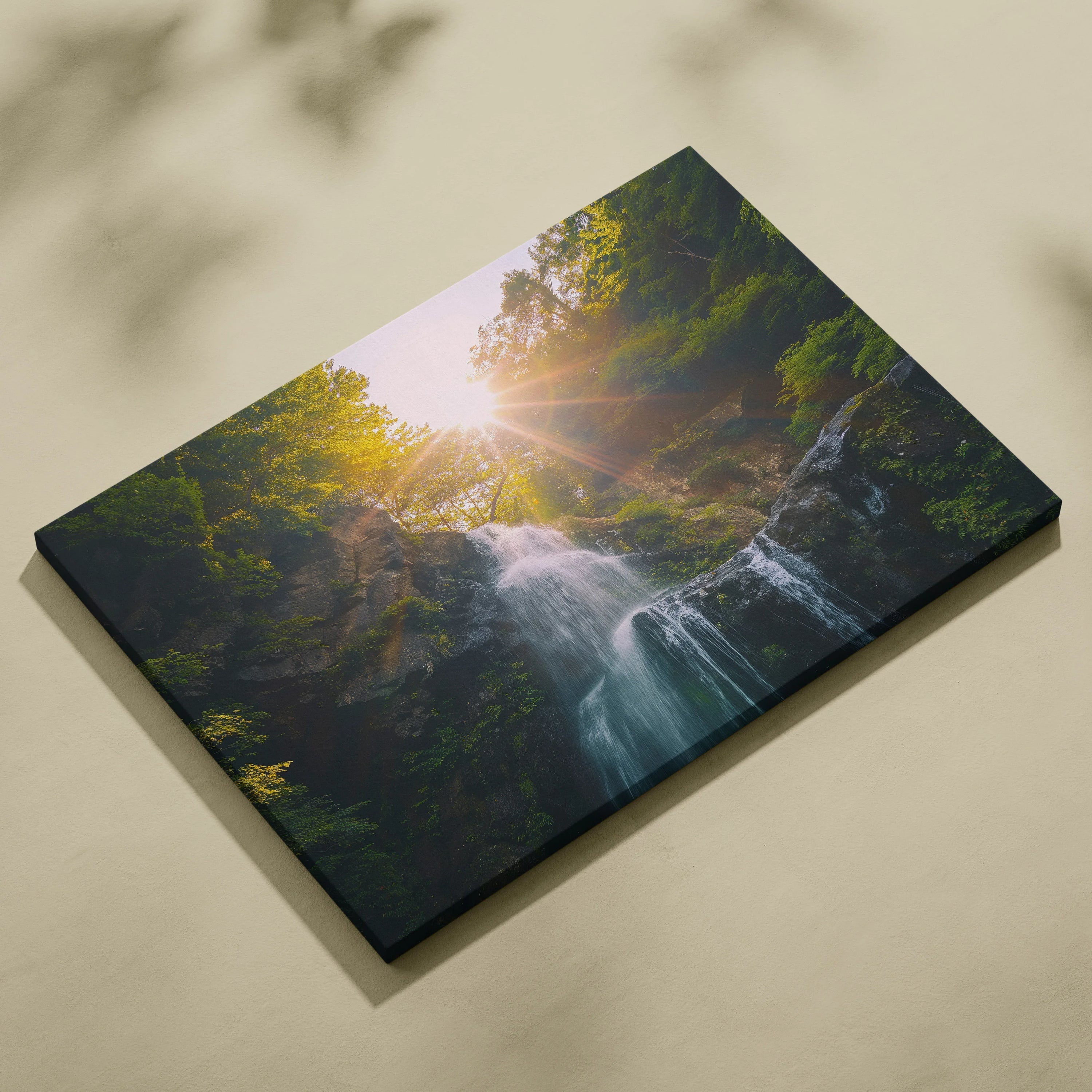 Canvas wall art featuring a high-resolution nature scene of a sunlit waterfall surrounded by lush green foliage.