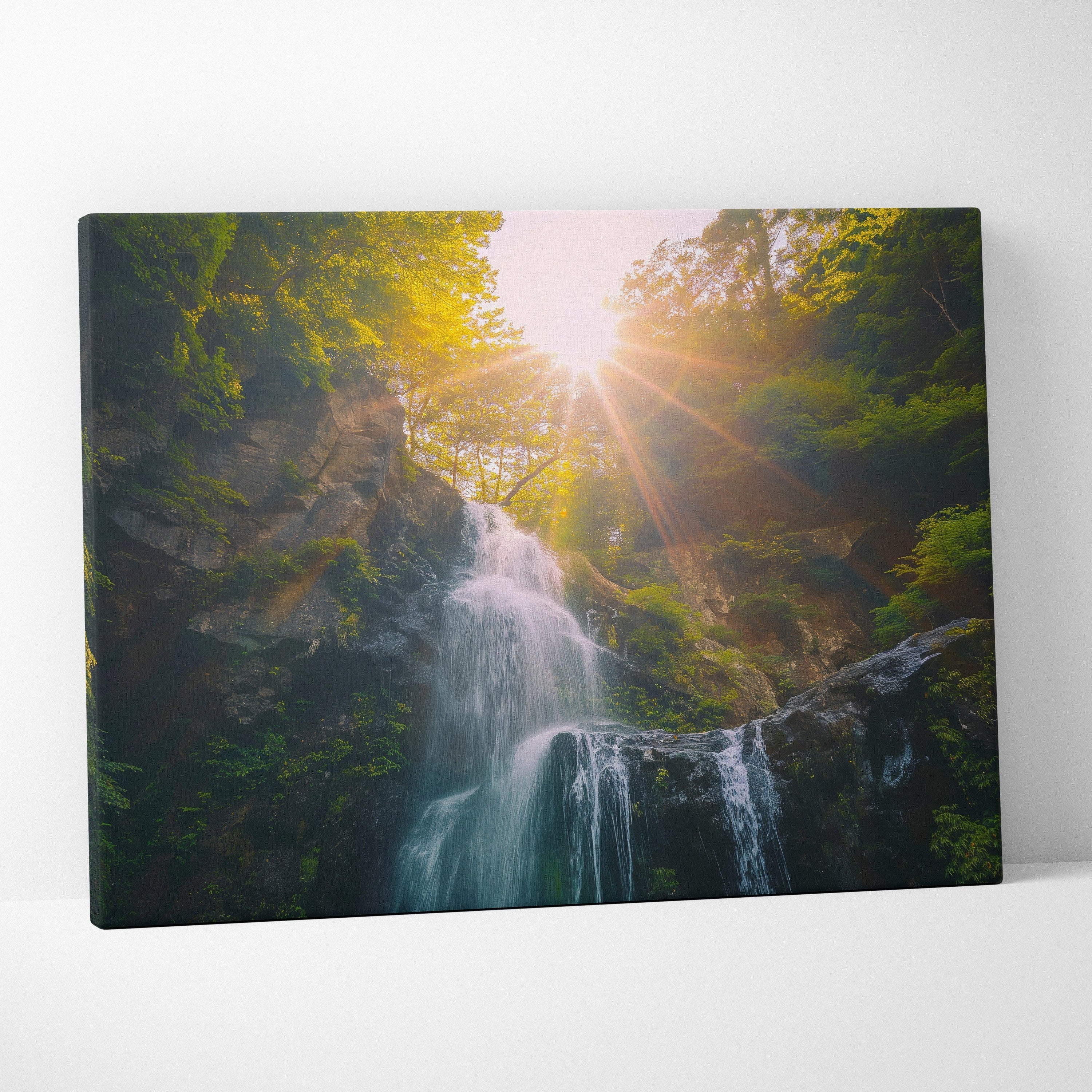 Canvas wall art featuring a vibrant waterfall cascading through lush green forest with sunlight streaming through trees.