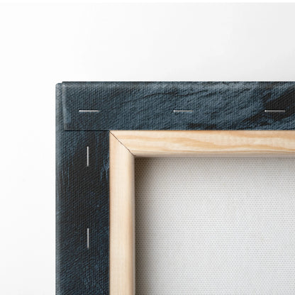 Close-up of wooden framed canvas with black painted edges and visible fabric texture on wall art backing.
