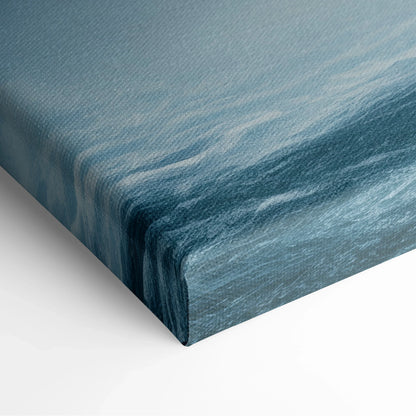 Canvas wall art depicting a rocky waterfall with mist in soft blue and gray tones.