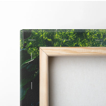 Close-up of stretched canvas featuring vibrant green tropical foliage with natural wood frame for wall art decor.