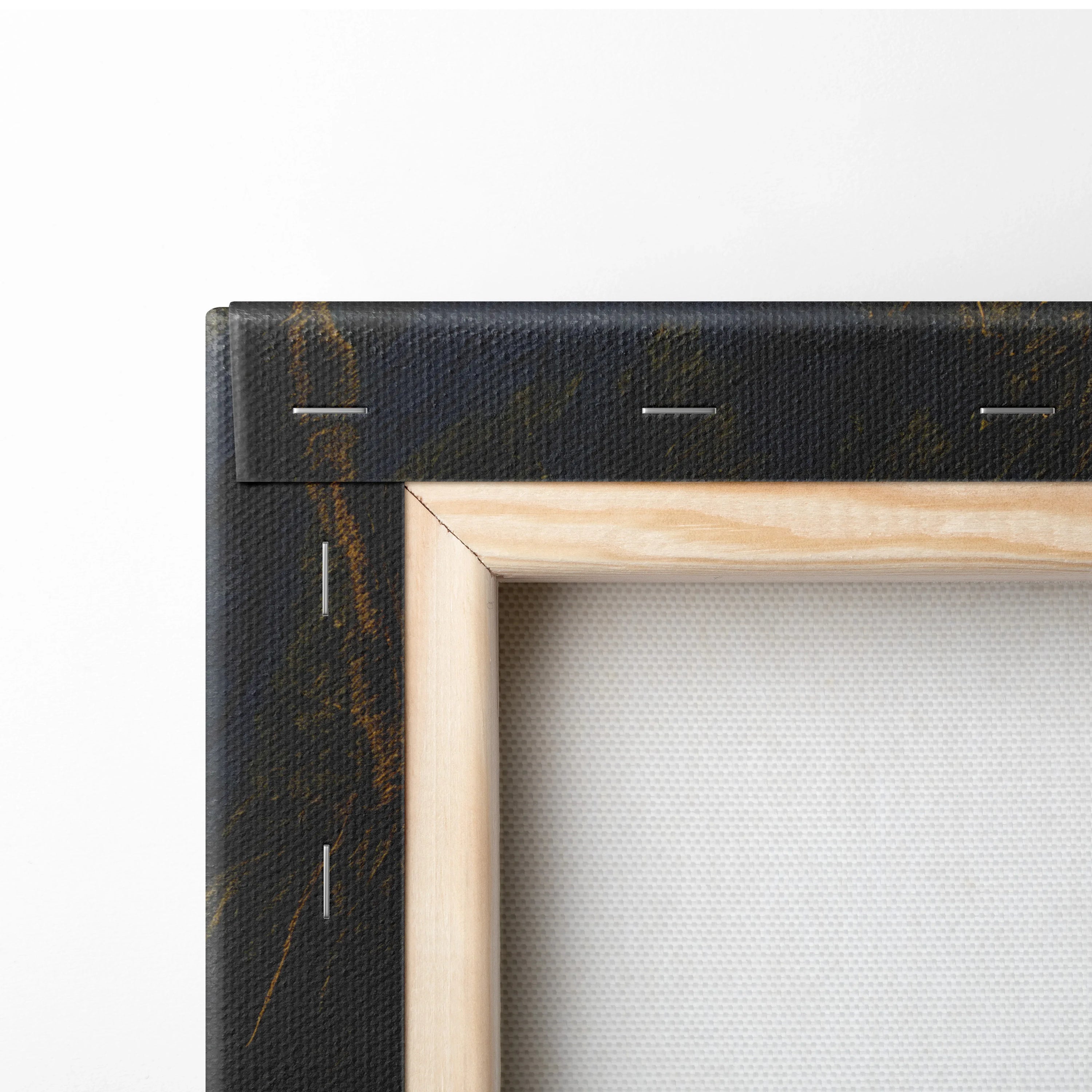 Close-up of wooden stretcher frame and black canvas edge with gold veining on wall art decor piece.