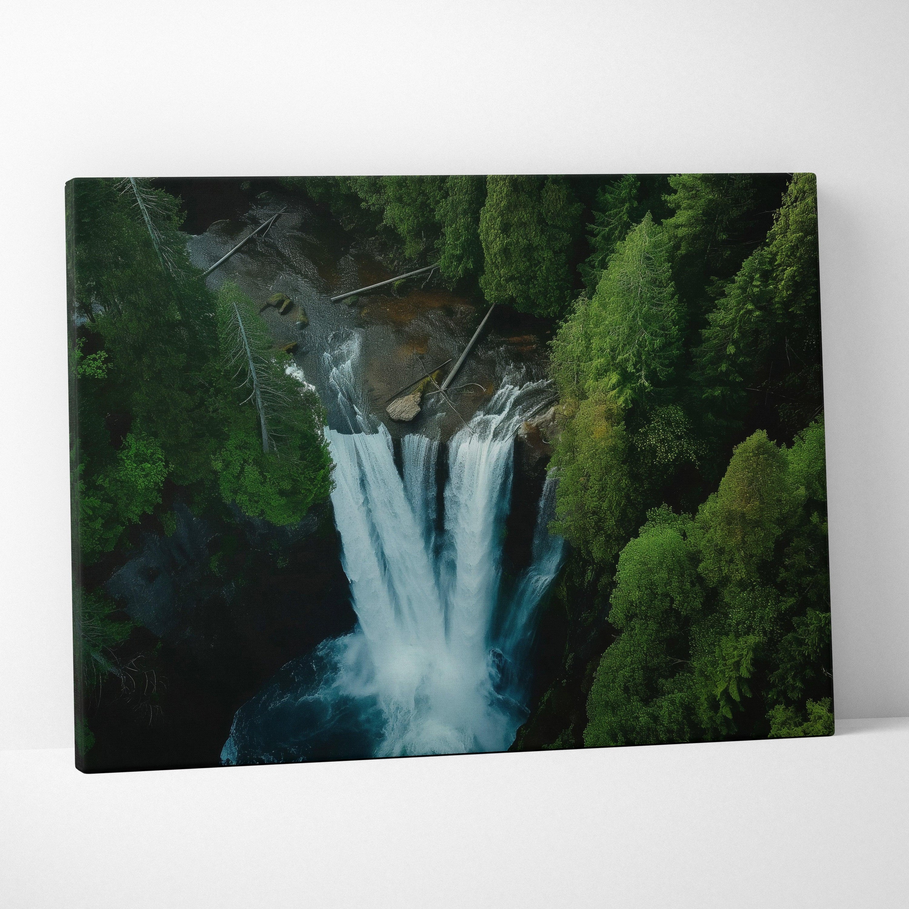 Aerial view forest waterfall canvas wall art with lush green trees and cascading water decor.