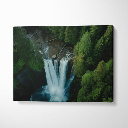 Aerial view canvas wall art of a waterfall surrounded by dense green forest decor.