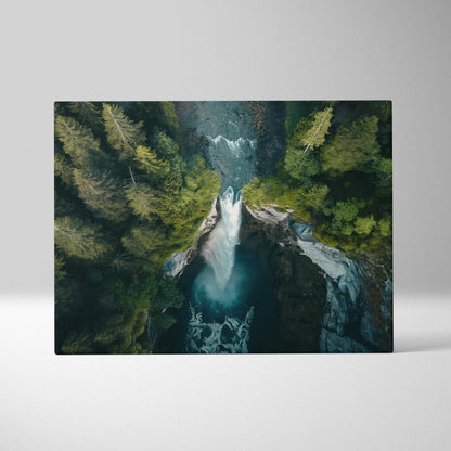 Canvas wall art featuring an aerial view of a forest waterfall surrounded by lush green trees and flowing water.