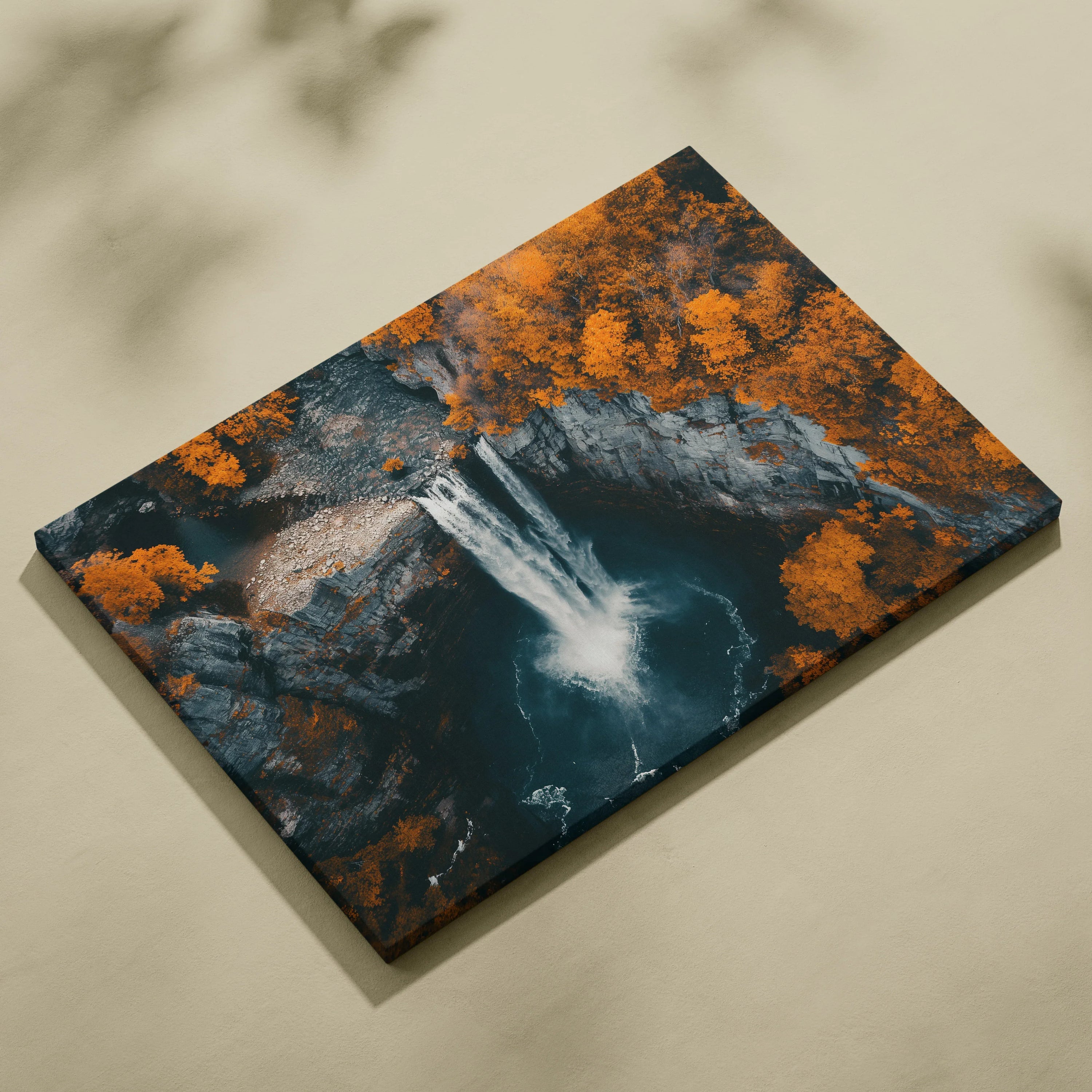 Rectangular canvas wall art featuring a waterfall cascading into a dark pool surrounded by forest with vibrant autumn orange