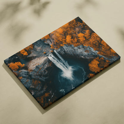 Rectangular canvas wall art featuring a waterfall cascading into a dark pool surrounded by forest with vibrant autumn orange