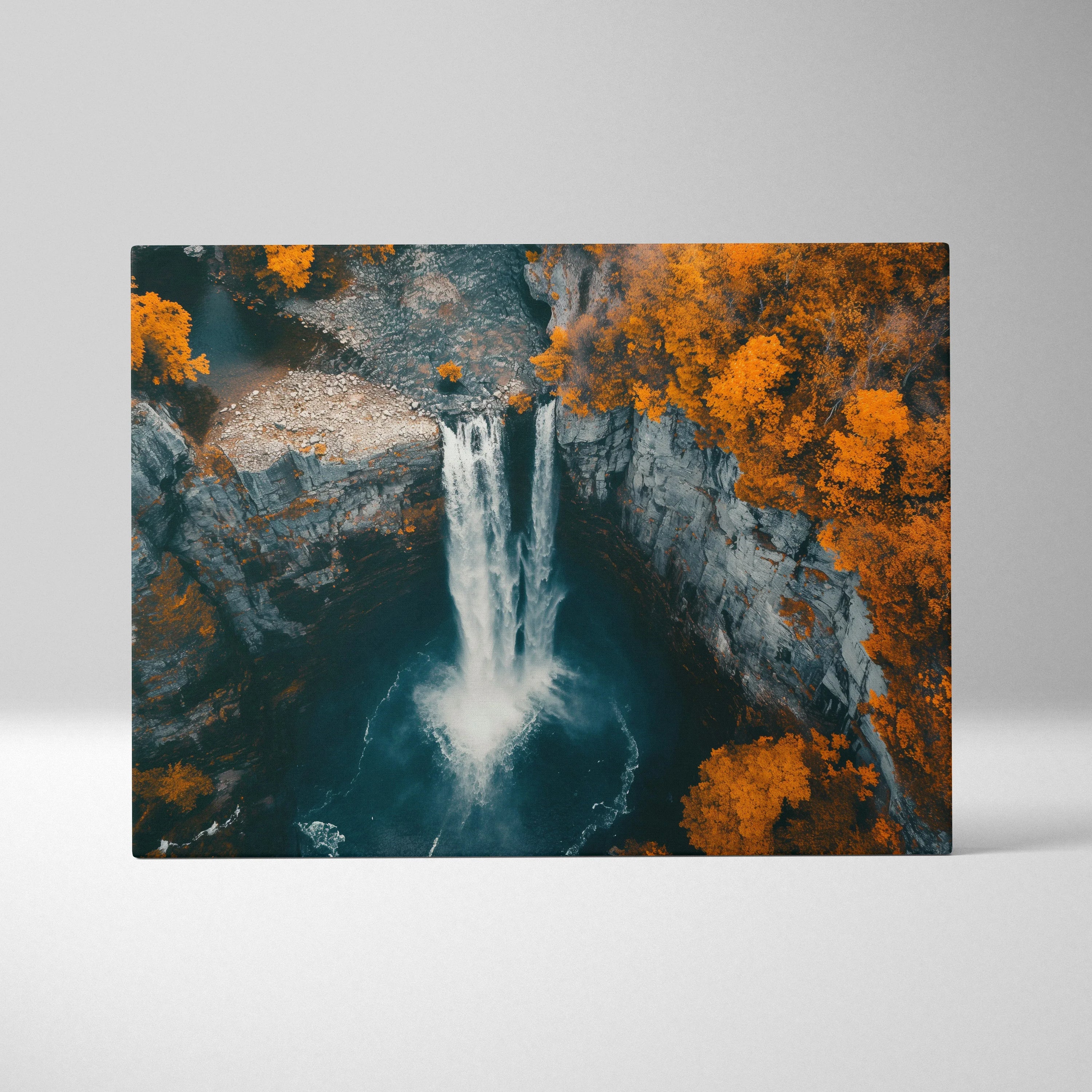 Canvas wall art featuring a vibrant forest landscape with a cascading waterfall and bright autumn orange foliage.