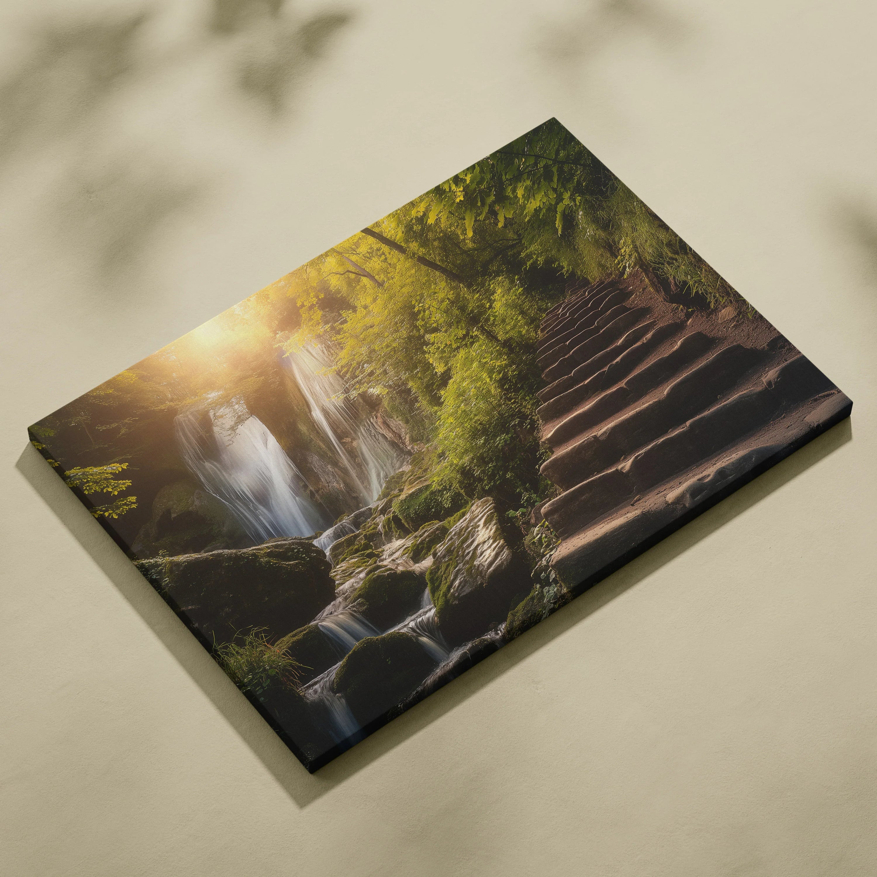 Canvas wall art featuring a stone stairway beside a lush green forest waterfall at sunset.