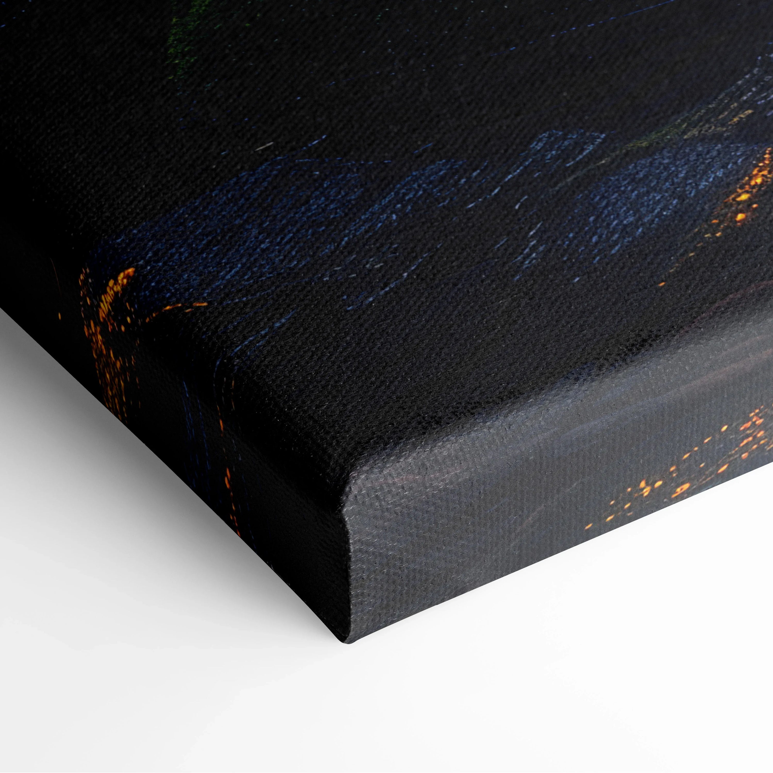 Close-up of black canvas edge with textured surface and hints of blue and orange digital art colors.
