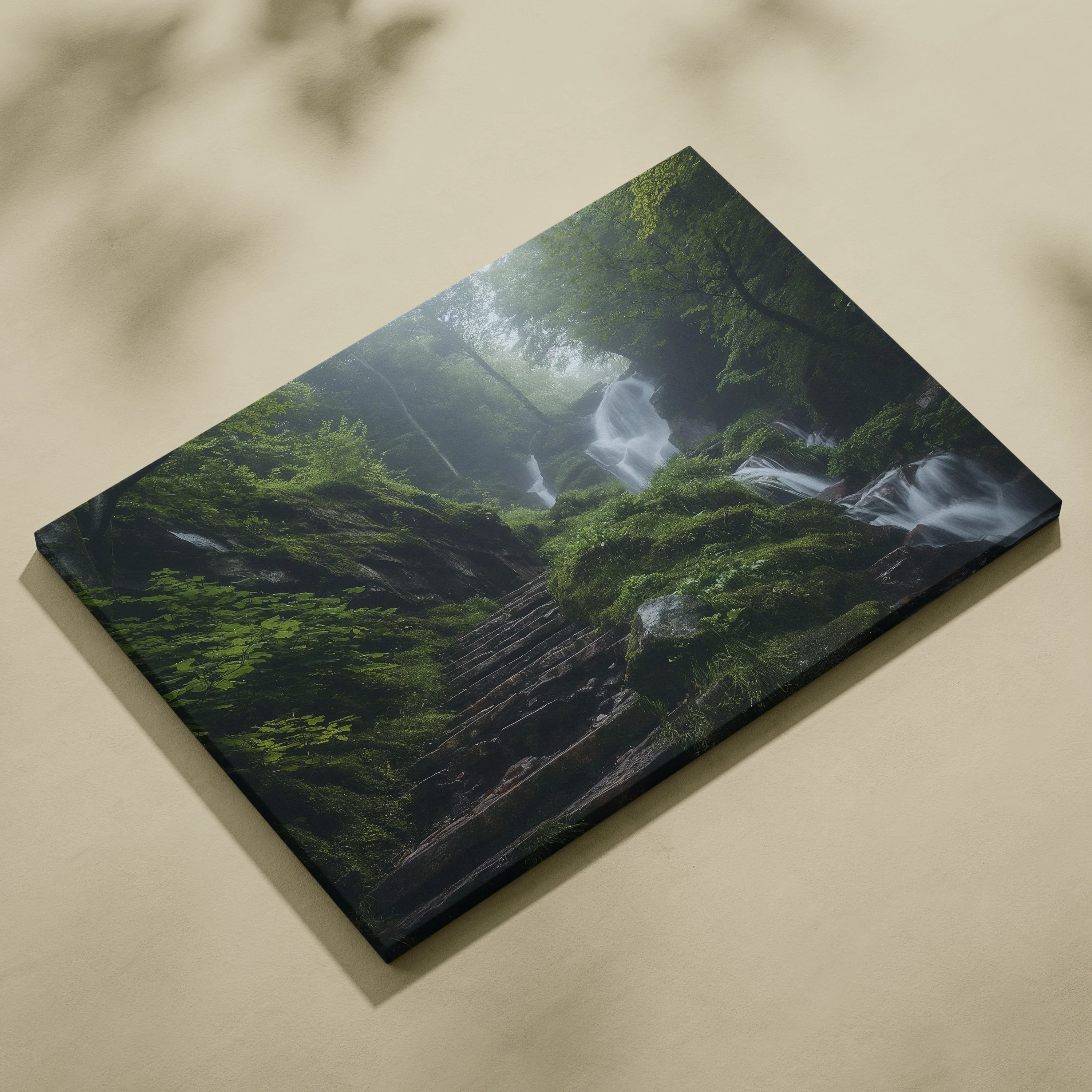 Canvas wall art depicting a misty waterfall cascading through a lush green forest with moss-covered rocks.