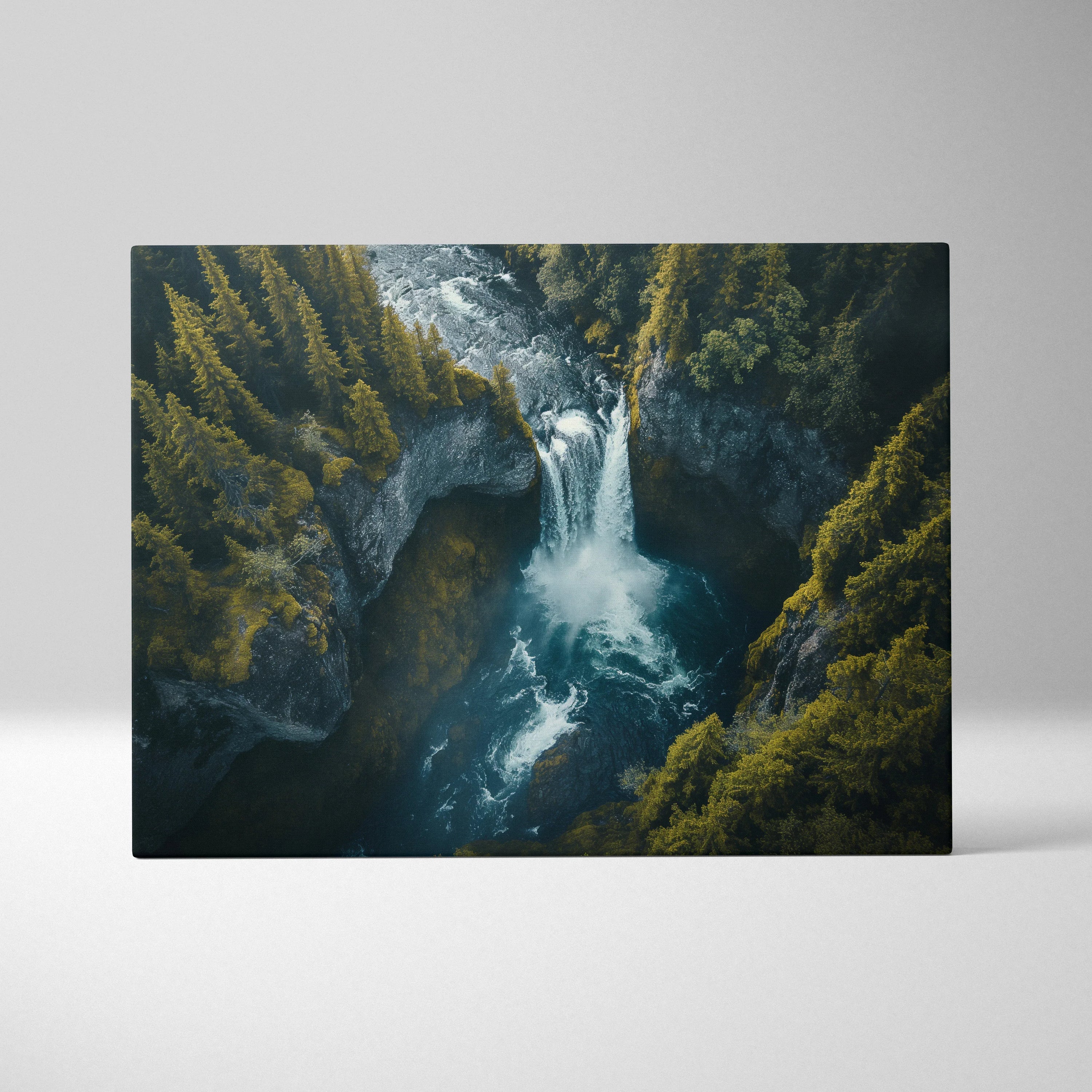 Canvas wall art featuring a vibrant waterfall cascading through rocky cliffs surrounded by lush green forest.