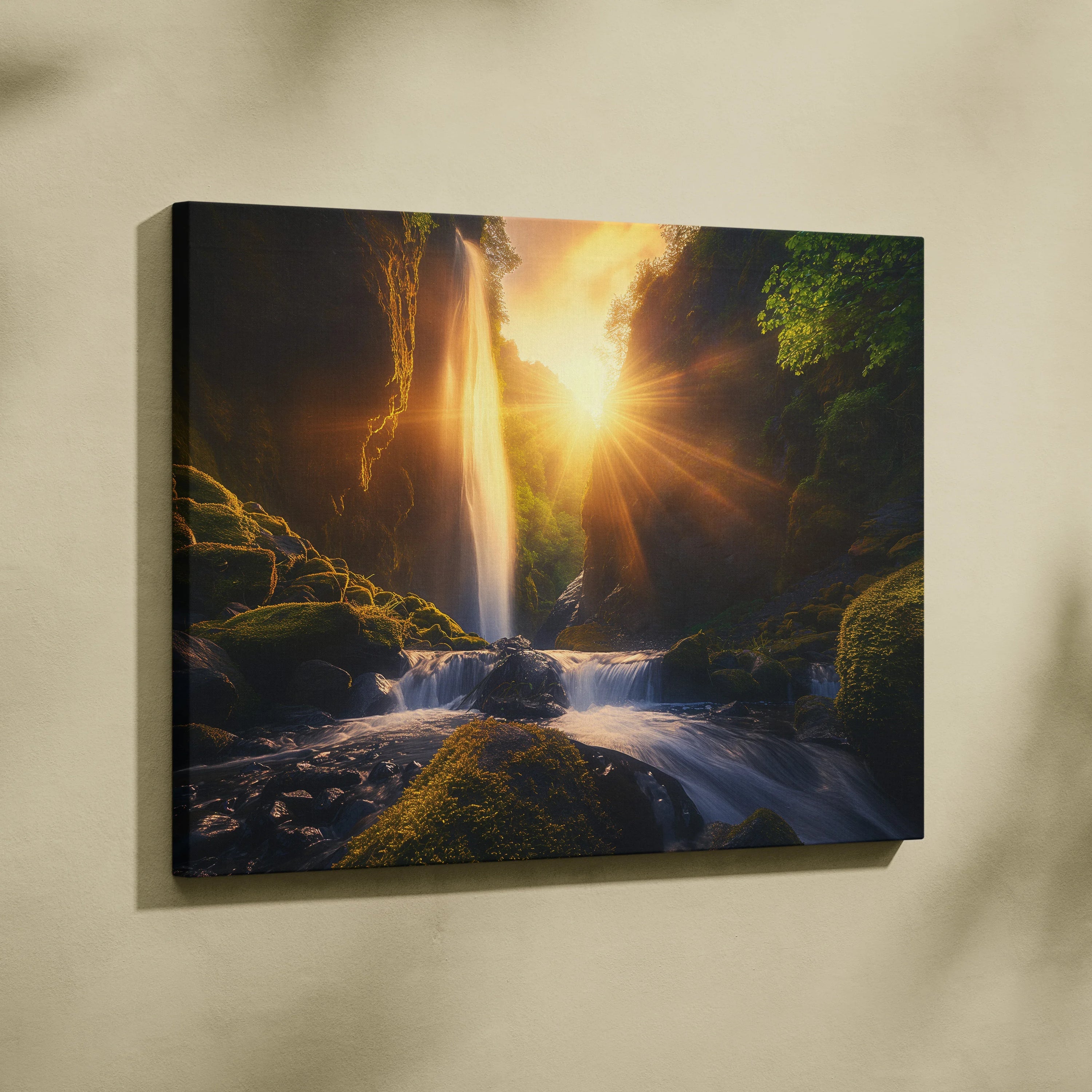Canvas wall art featuring a glowing forest waterfall at sunset with warm golden light and green mossy rocks.