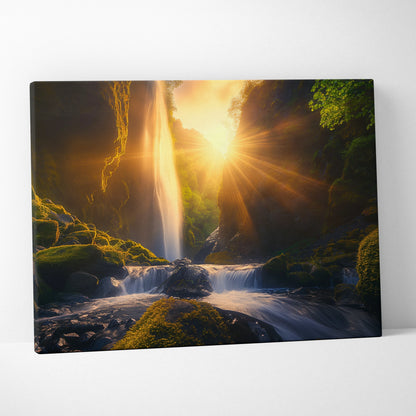 Canvas wall art featuring a glowing sunset behind a cascading waterfall in a lush green forest landscape.