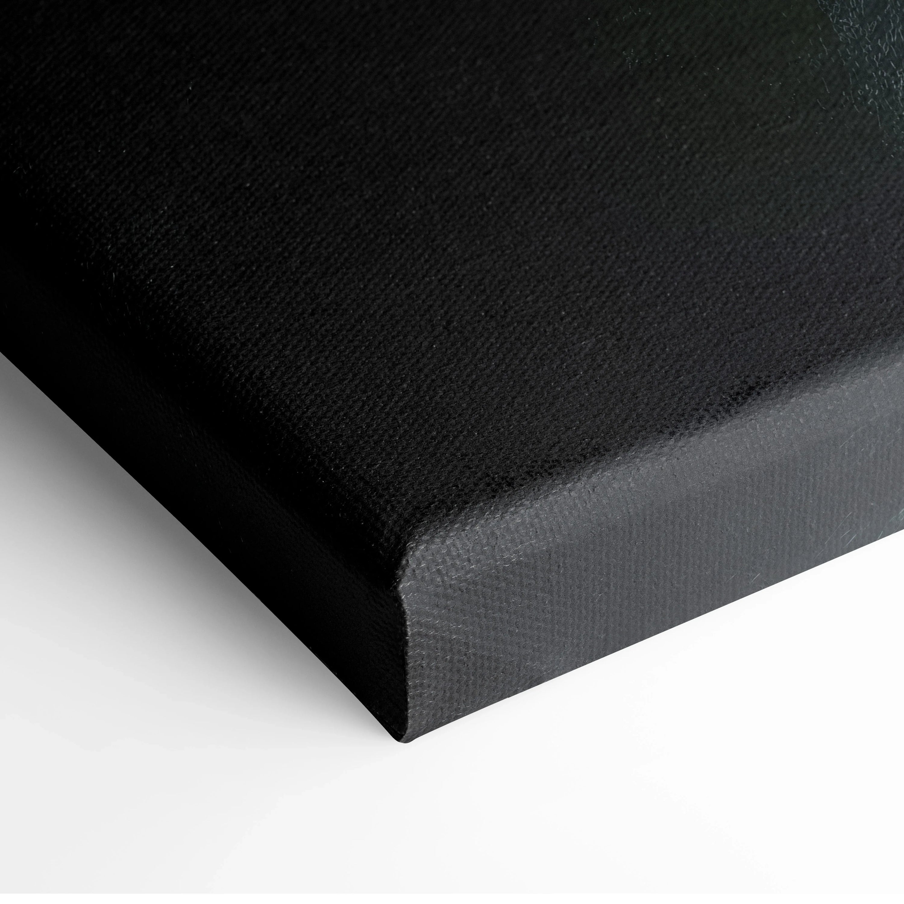 Close-up of black stretched canvas with textured fabric surface and wrapped edges for wall art decor.