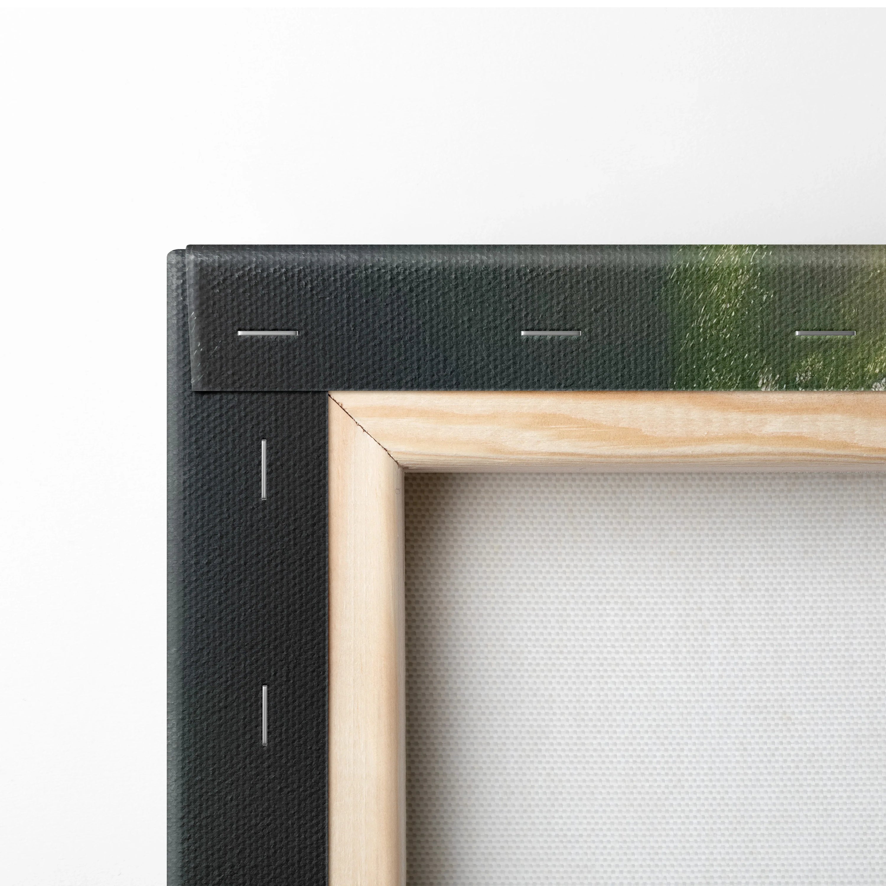 Corner detail of waterfall canvas wall art with black sides and natural wood frame backing.