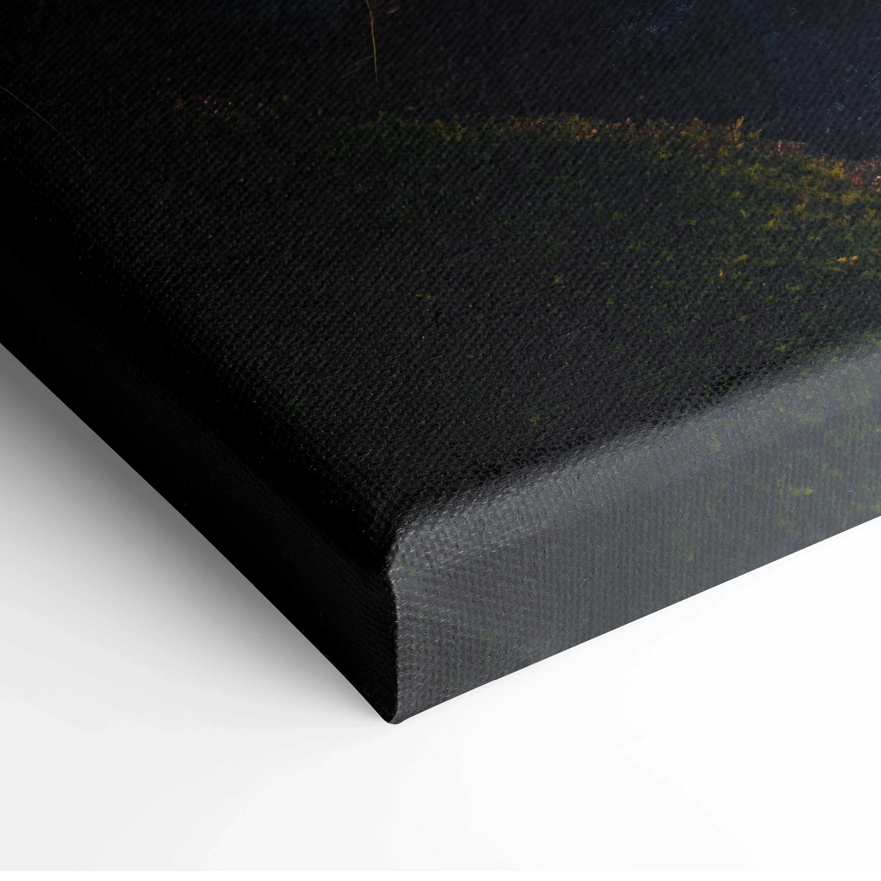 Corner detail of black canvas wall art with subtle green forest and waterfall decor texture.