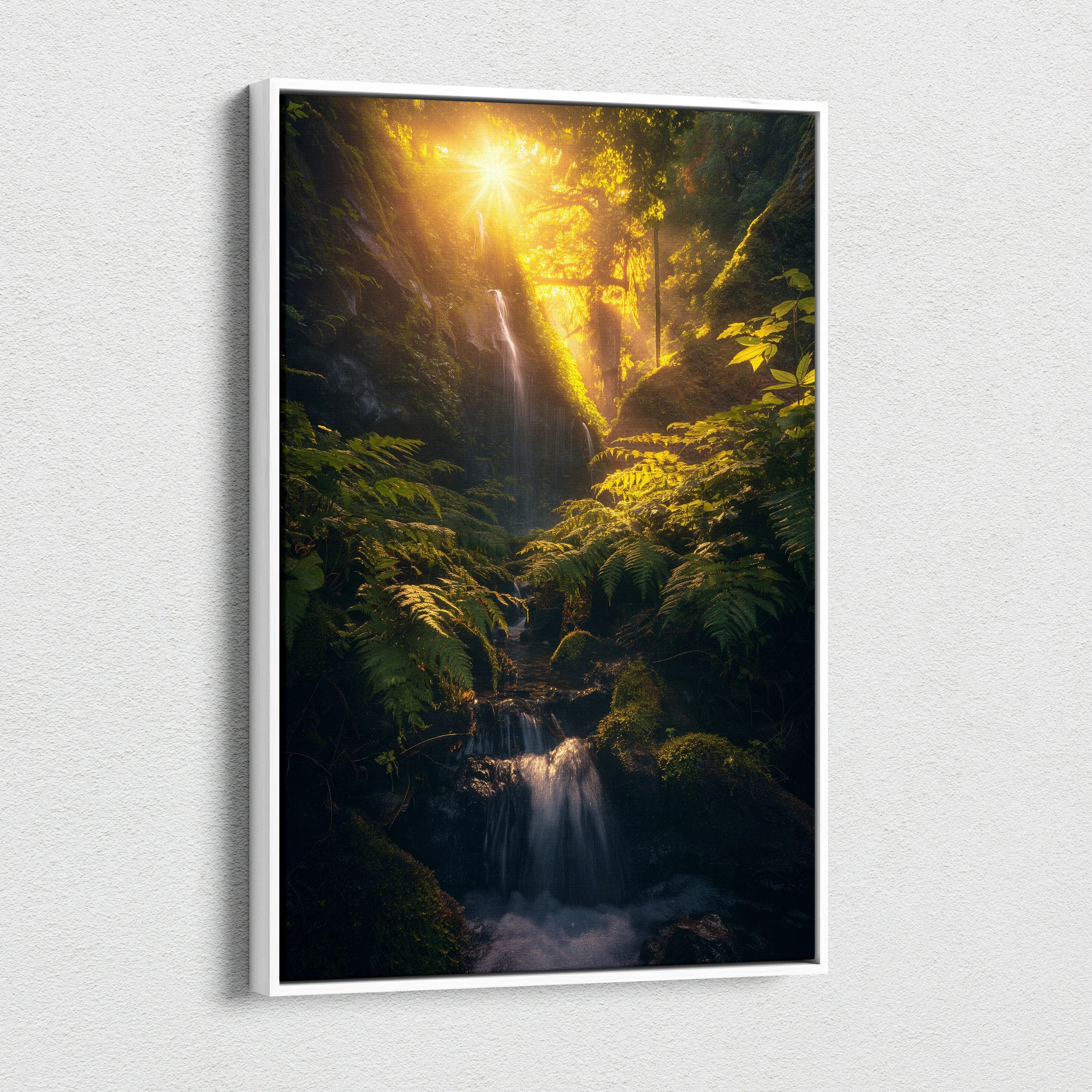 Vertical canvas wall art depicting a glowing waterfall cascading through dense green forest foliage at sunset.