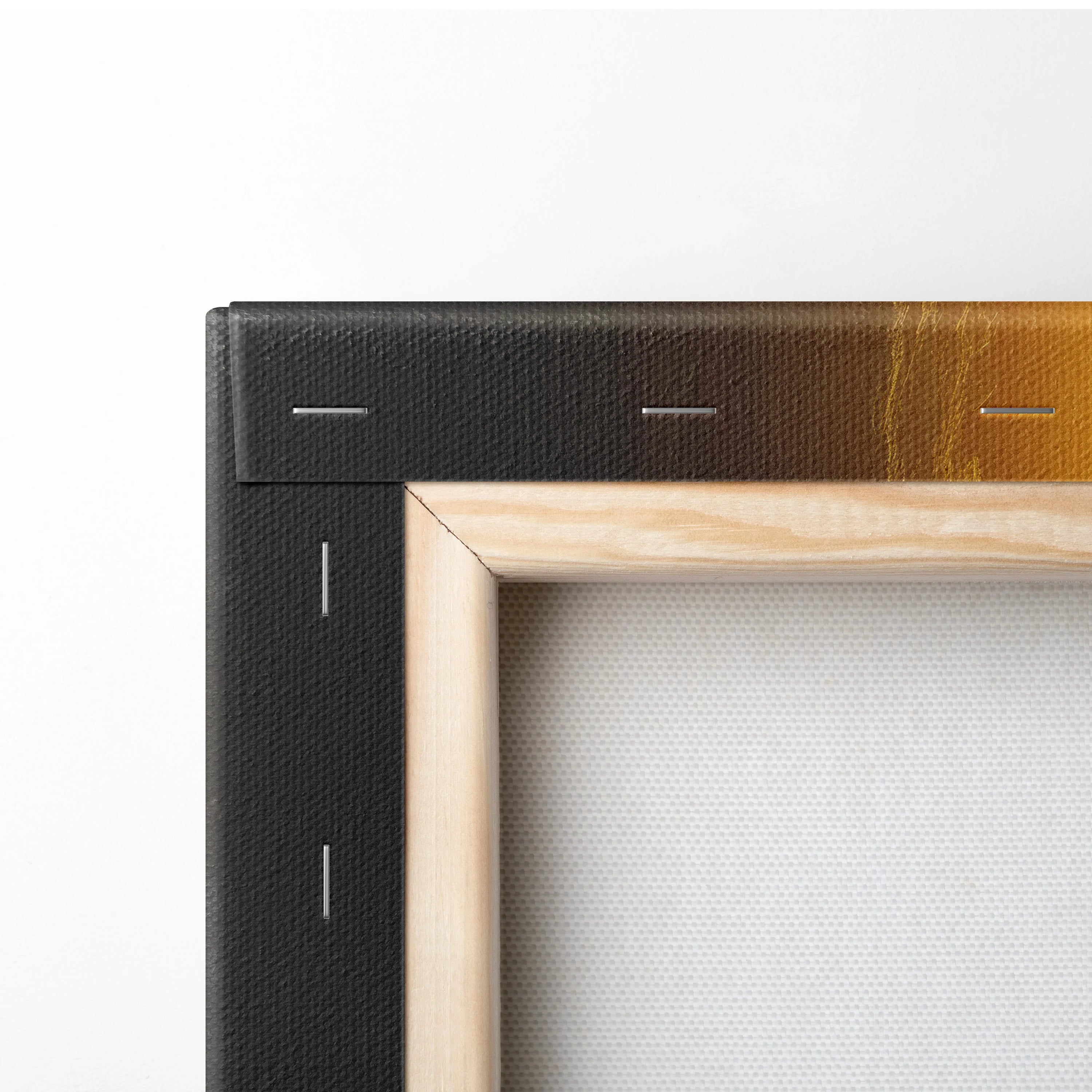 Close-up of stretched canvas with natural wood frame and black backboard staples for wall art decor.