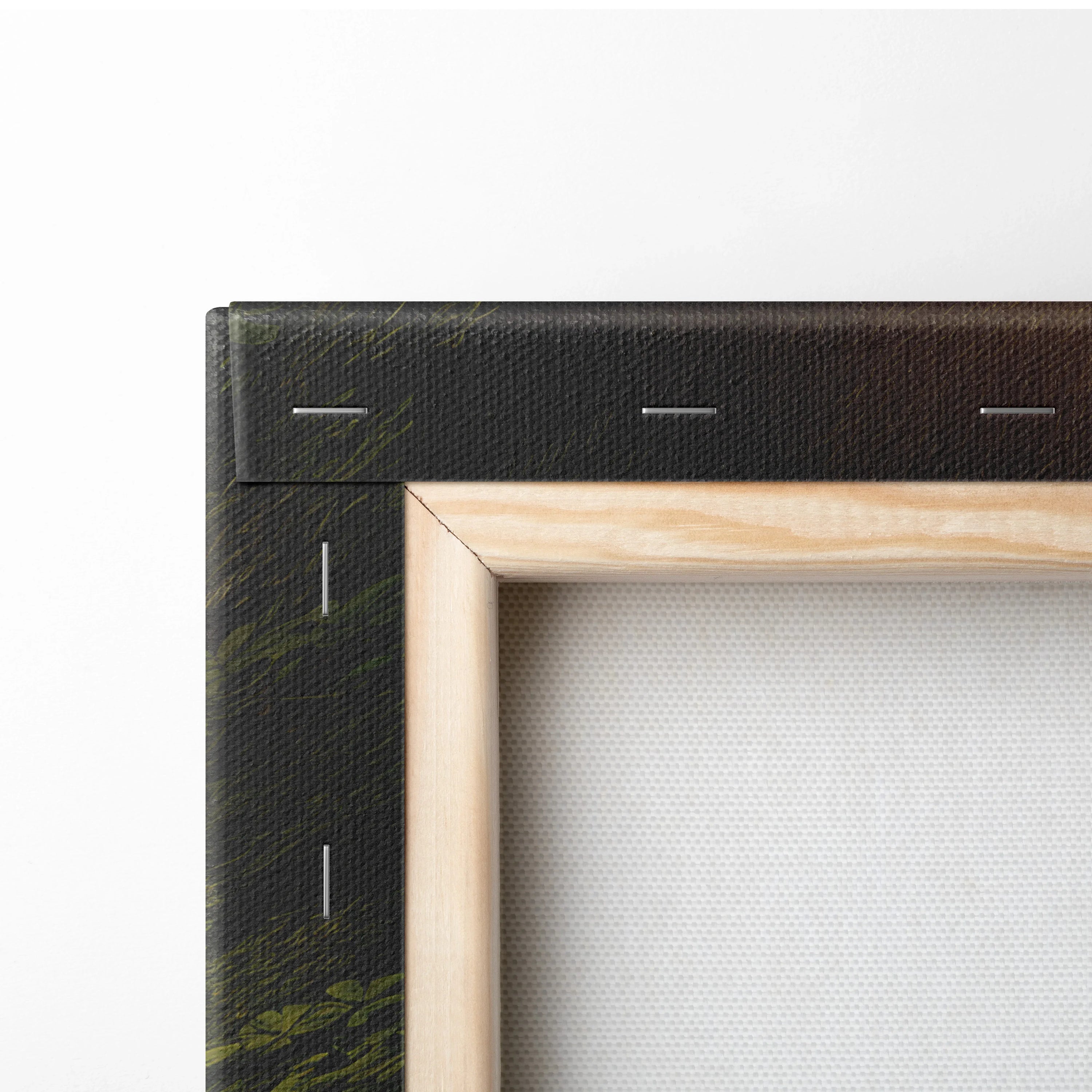 Close-up of wooden frame corner with black canvas edge and white fabric backing for wall art decor.
