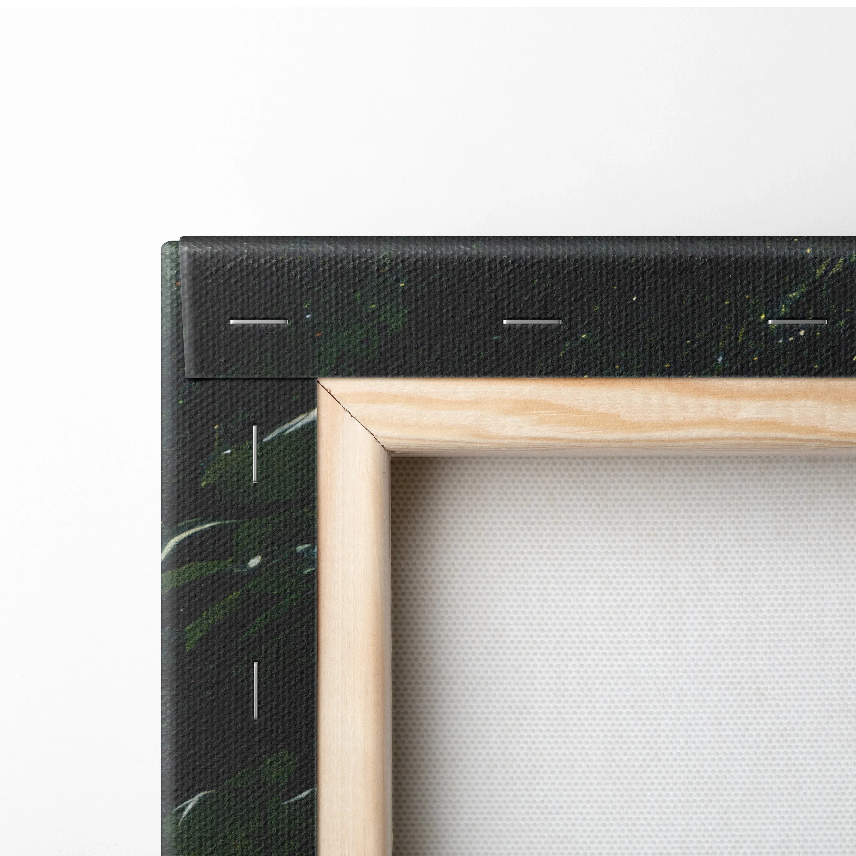 Close-up of natural wood frame corner with black canvas edge showing forest and waterfall print texture.