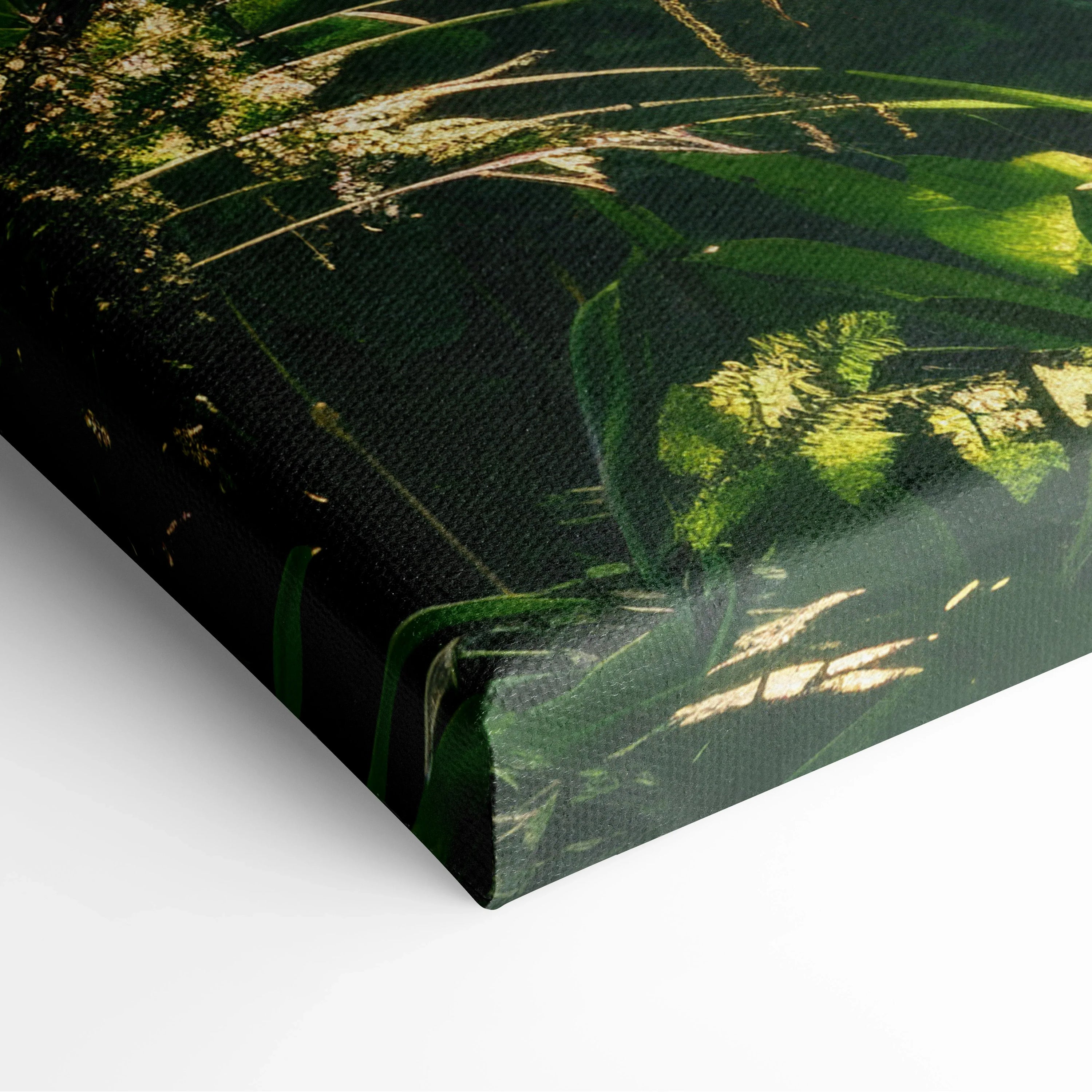 Close-up of canvas wall art featuring lush green tropical forest foliage with sunlight filtering through leaves.